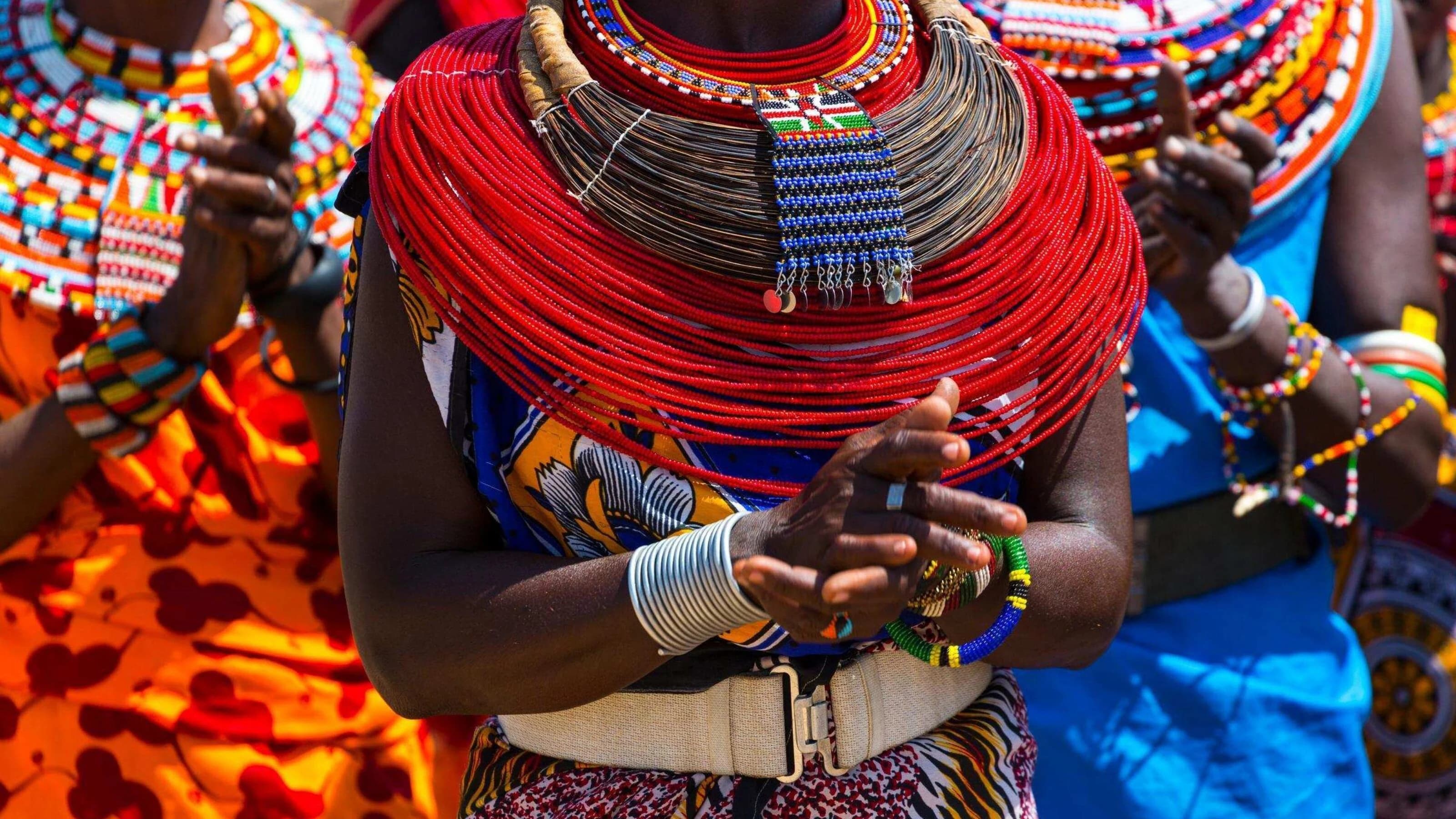 Red beaded necklace and clasped hands of a Samburu woman, face out of frame