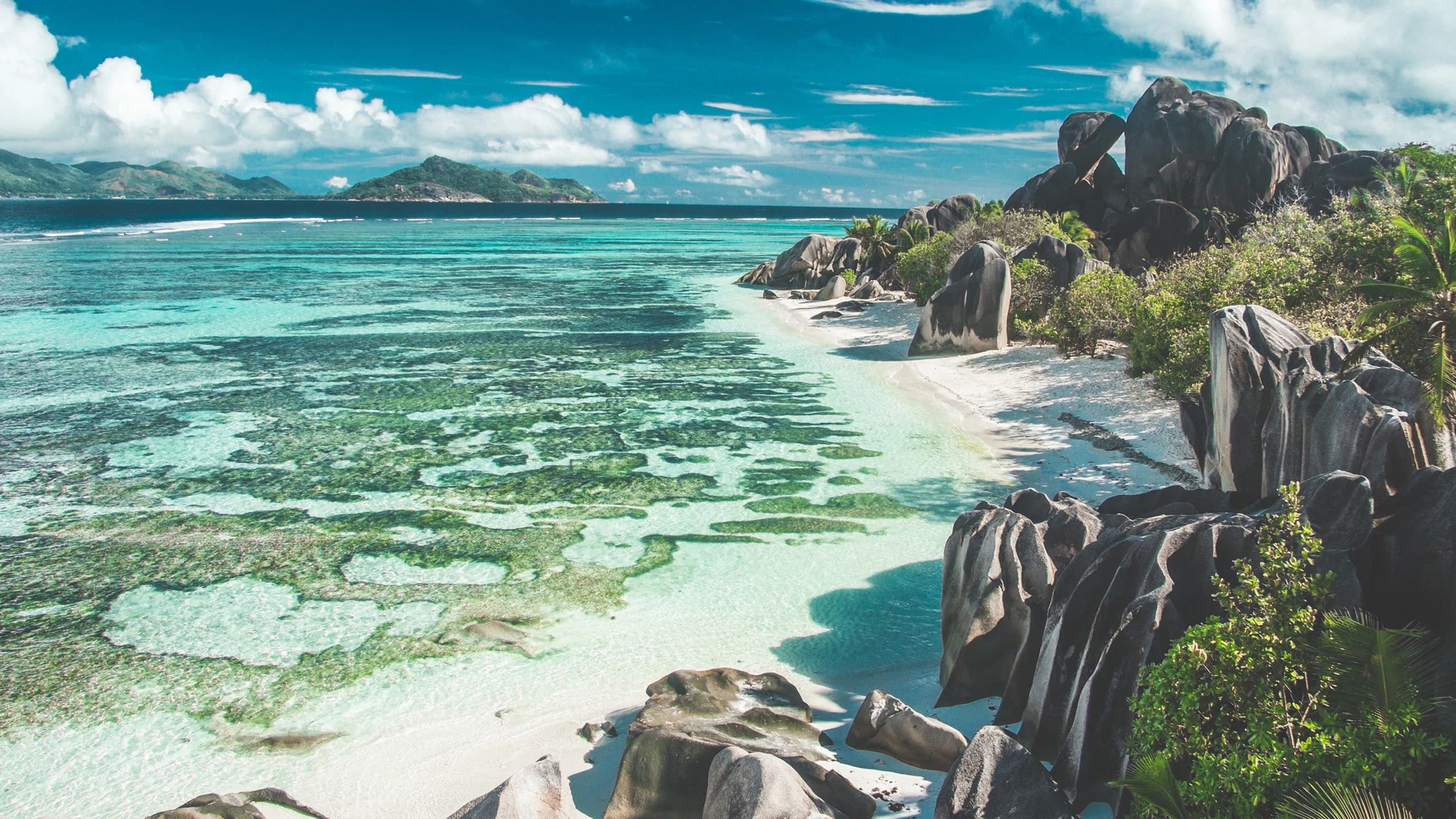 Granite boulders and turquoise lagoon on a Seychelles beach