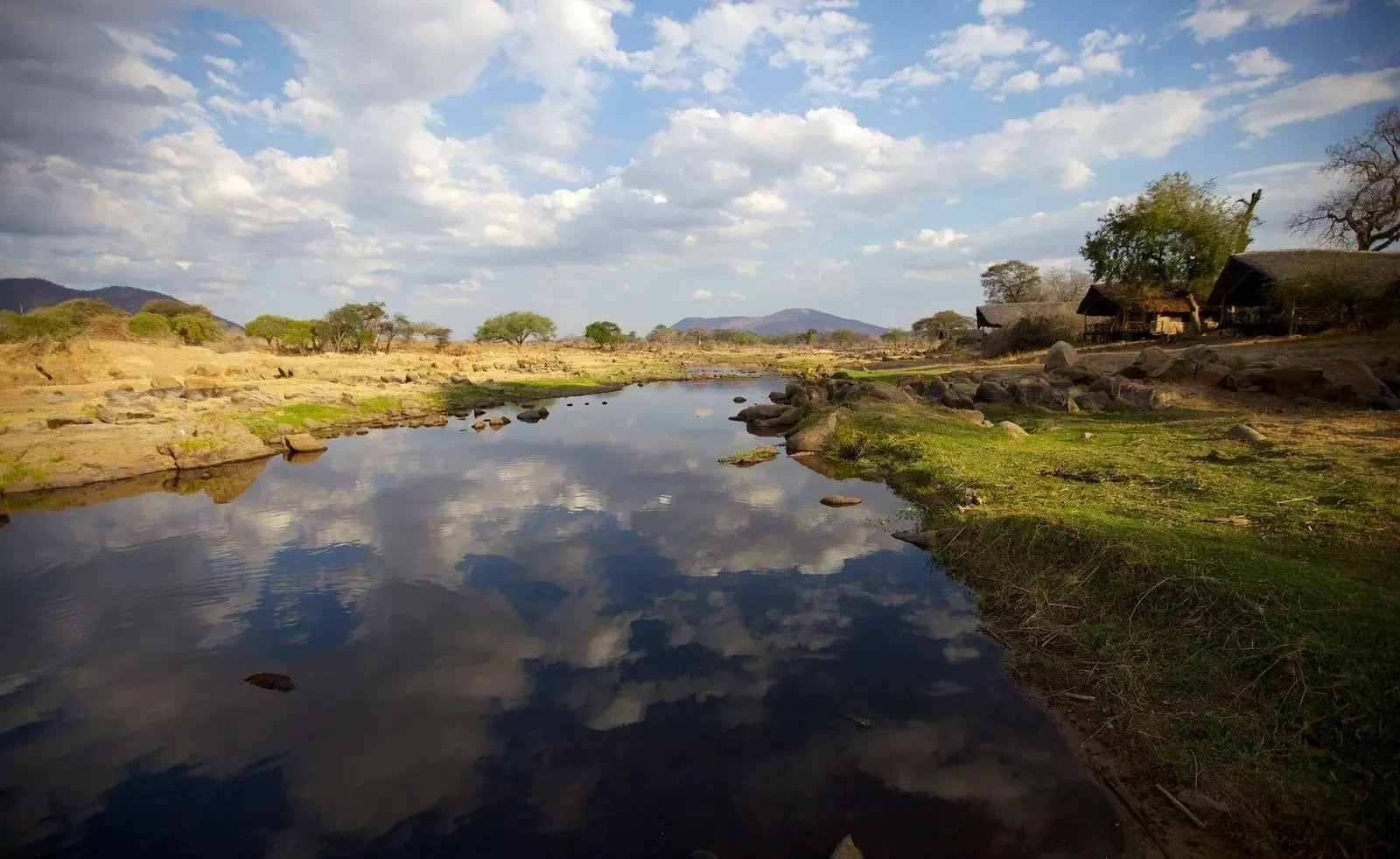 The Great Ruaha lies still beneath the hills, the dry-season bush drawn down to the water.