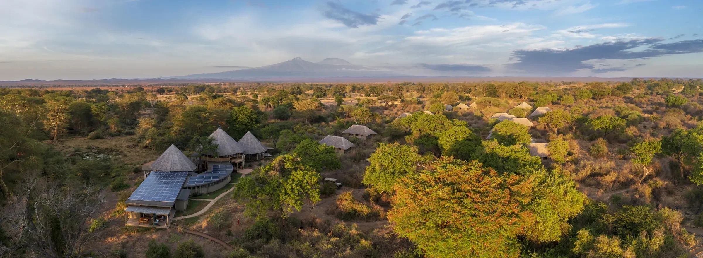 Dawn settles over the Chyulu Hills, the green rolling toward Kilimanjaro.