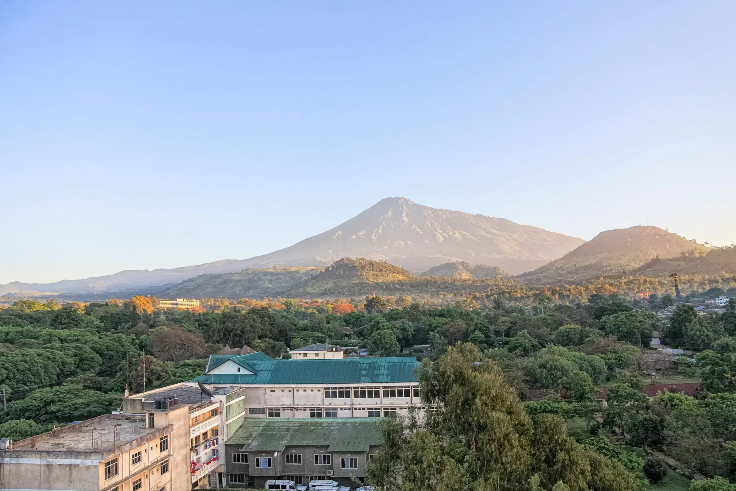 Mount Meru rises above Arusha, the town gathered at its foot.