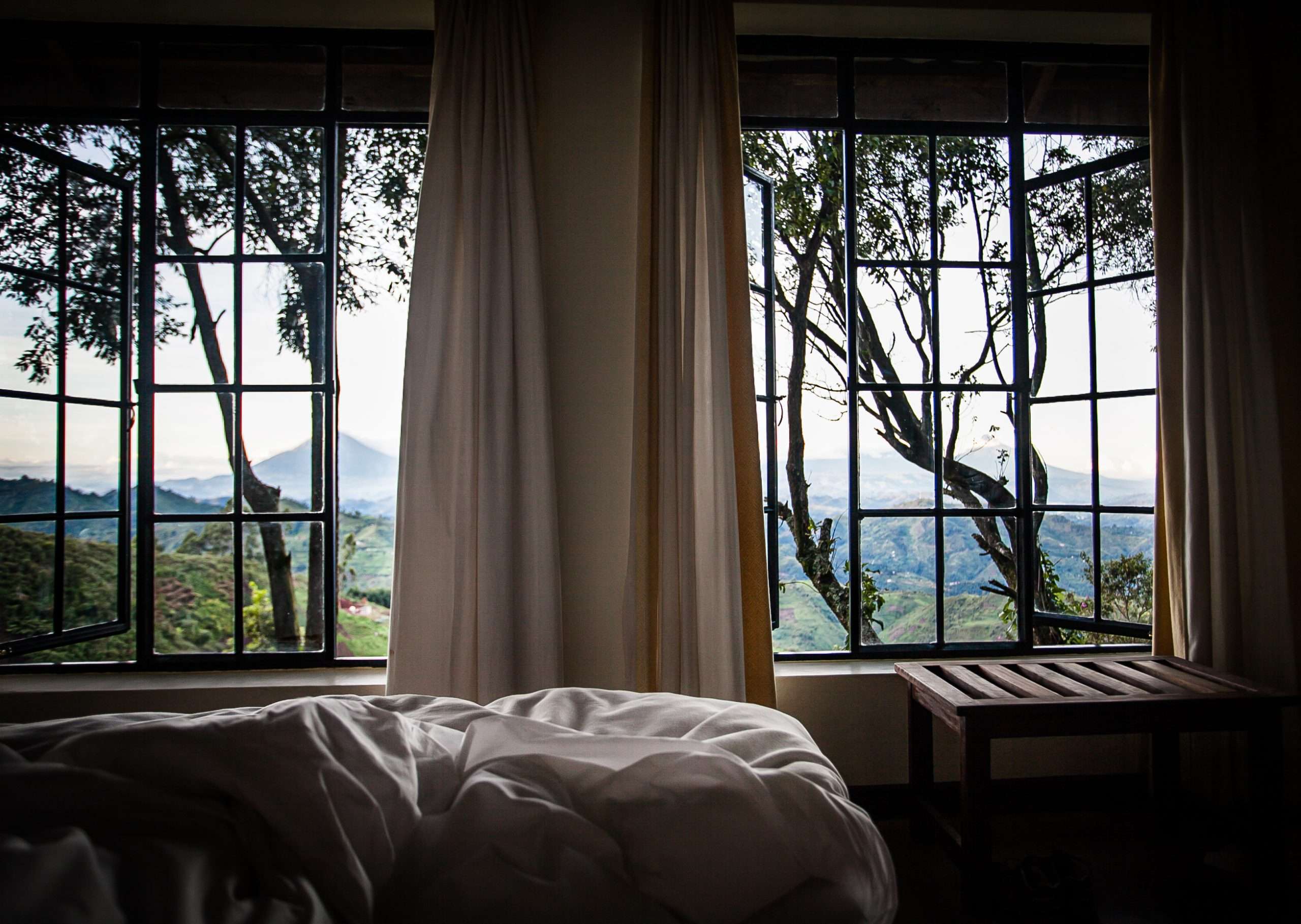 Bedroom with a mountain outlook at Clouds Mountain Gorilla Lodge