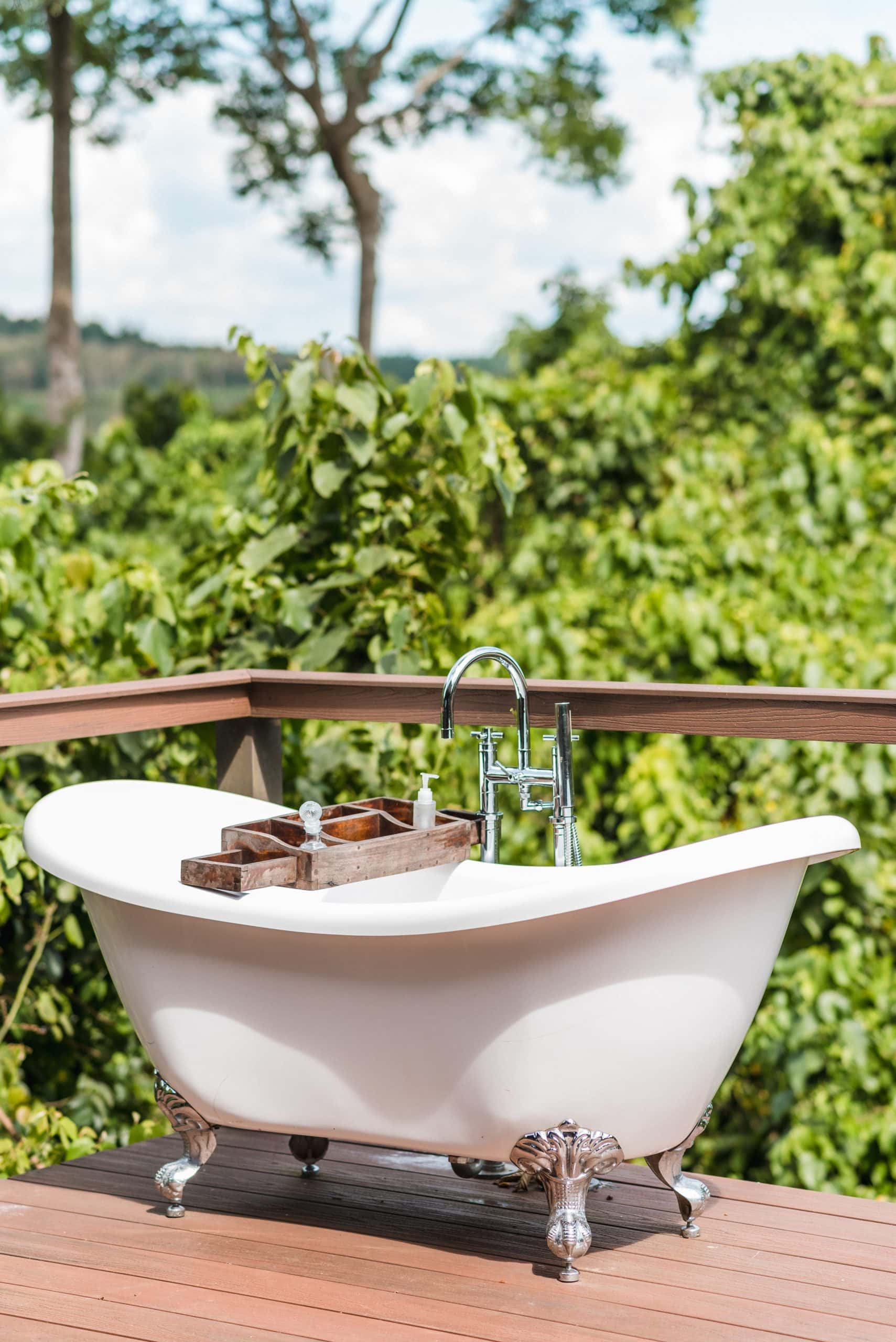 Outdoor bath among trees at Lemala Wildwaters Lodge