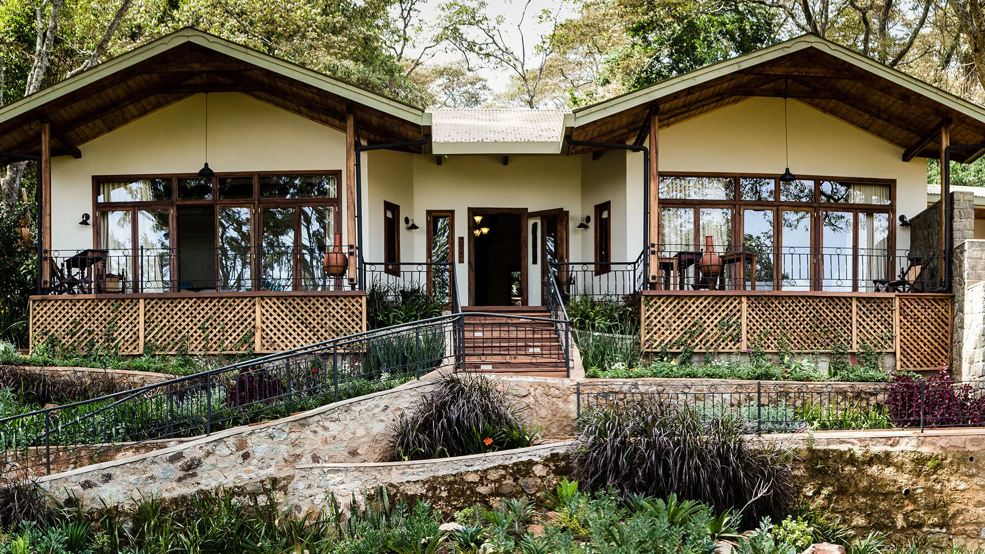 Veranda-fronted farmhouse cottage with a garden path at Gibbs Farm