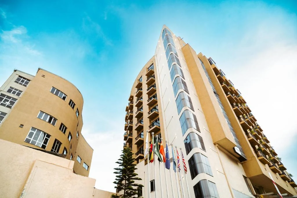 a tall building with american flags in front of it