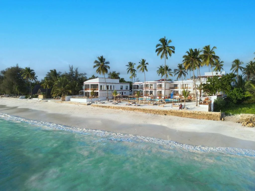 a view of a beach with palm trees and houses