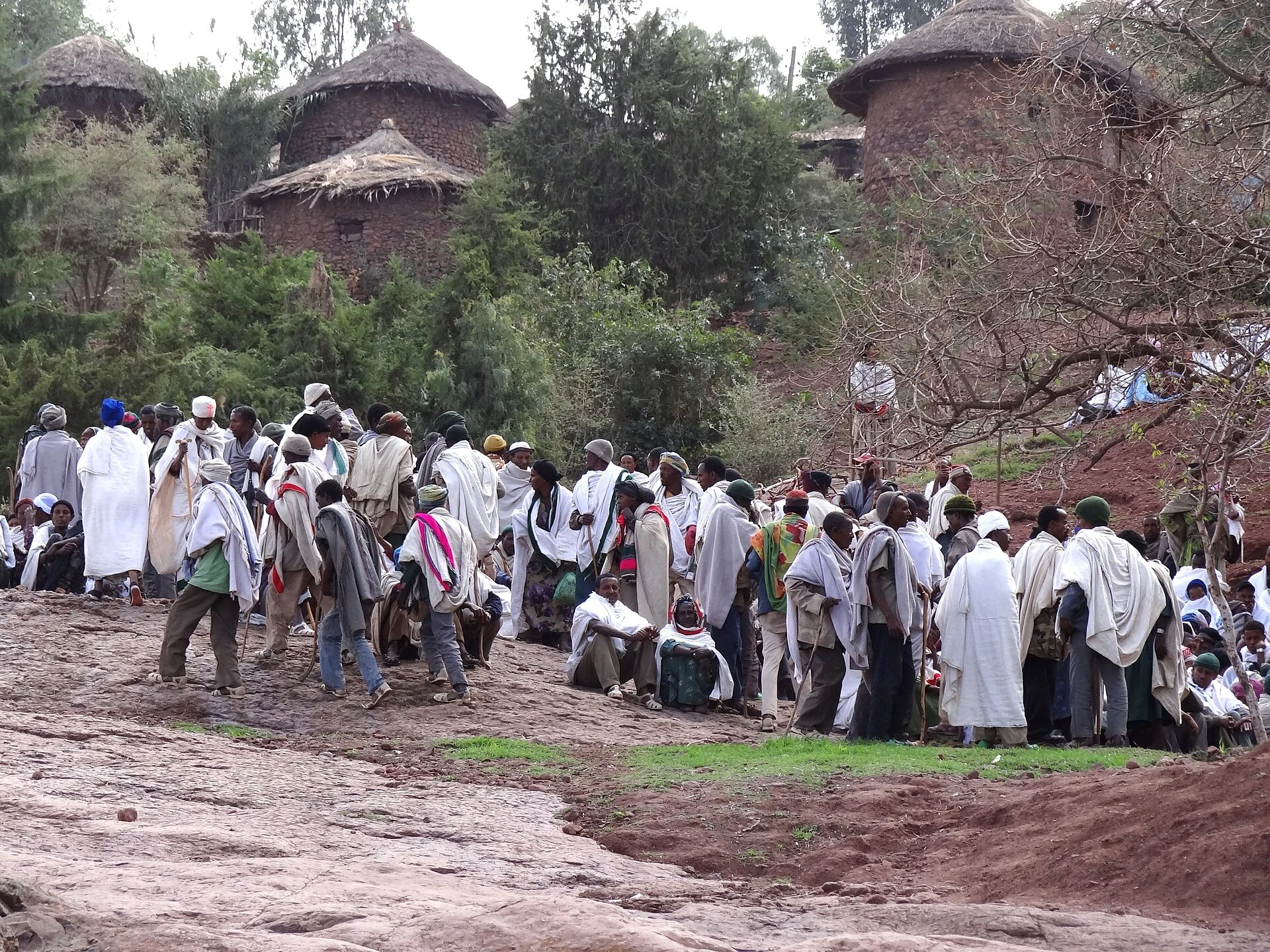 Crowds of white-robed pilgrims gather among the round houses of Lalibela.