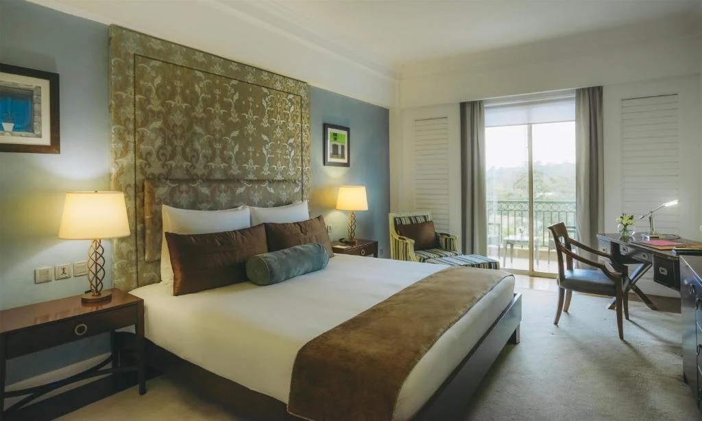 a hotel room with a large bed and a desk