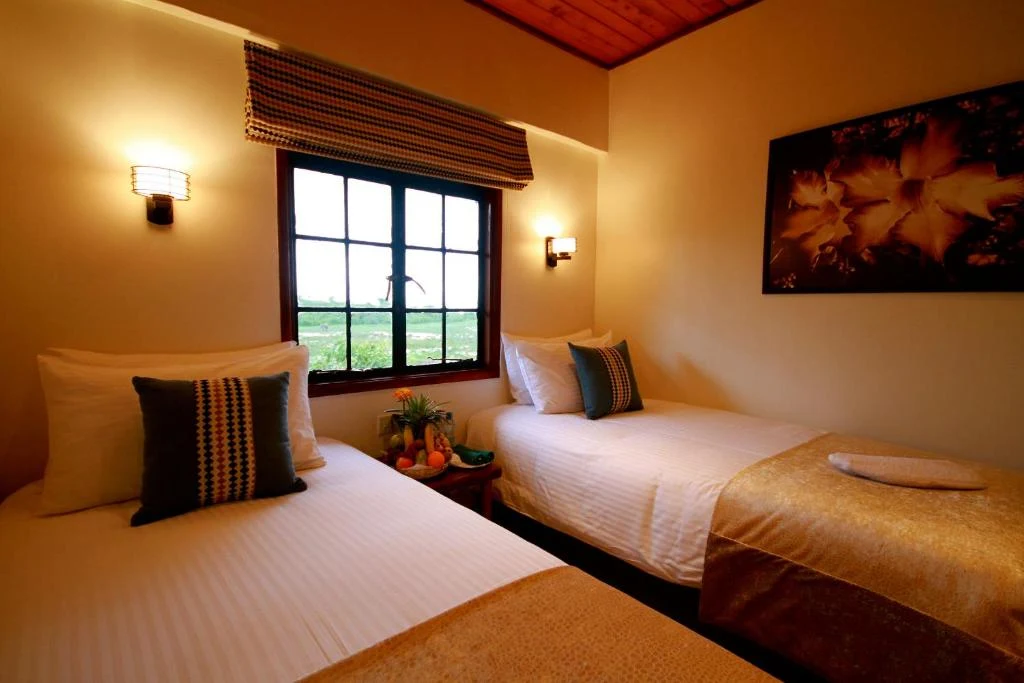 Twin beds in a wood-ceiling guest room