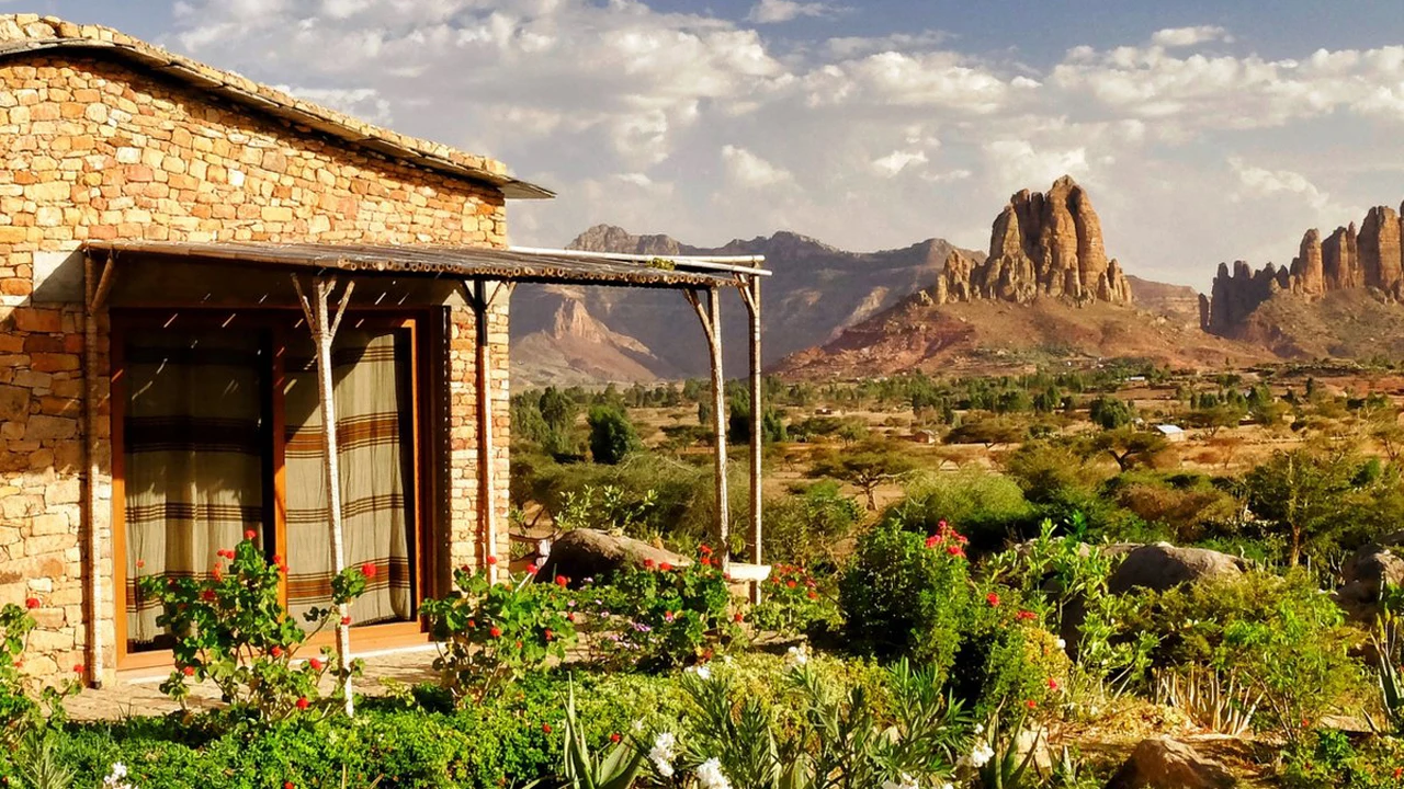 Stone cottage beneath rocky hills at Korkor Lodge
