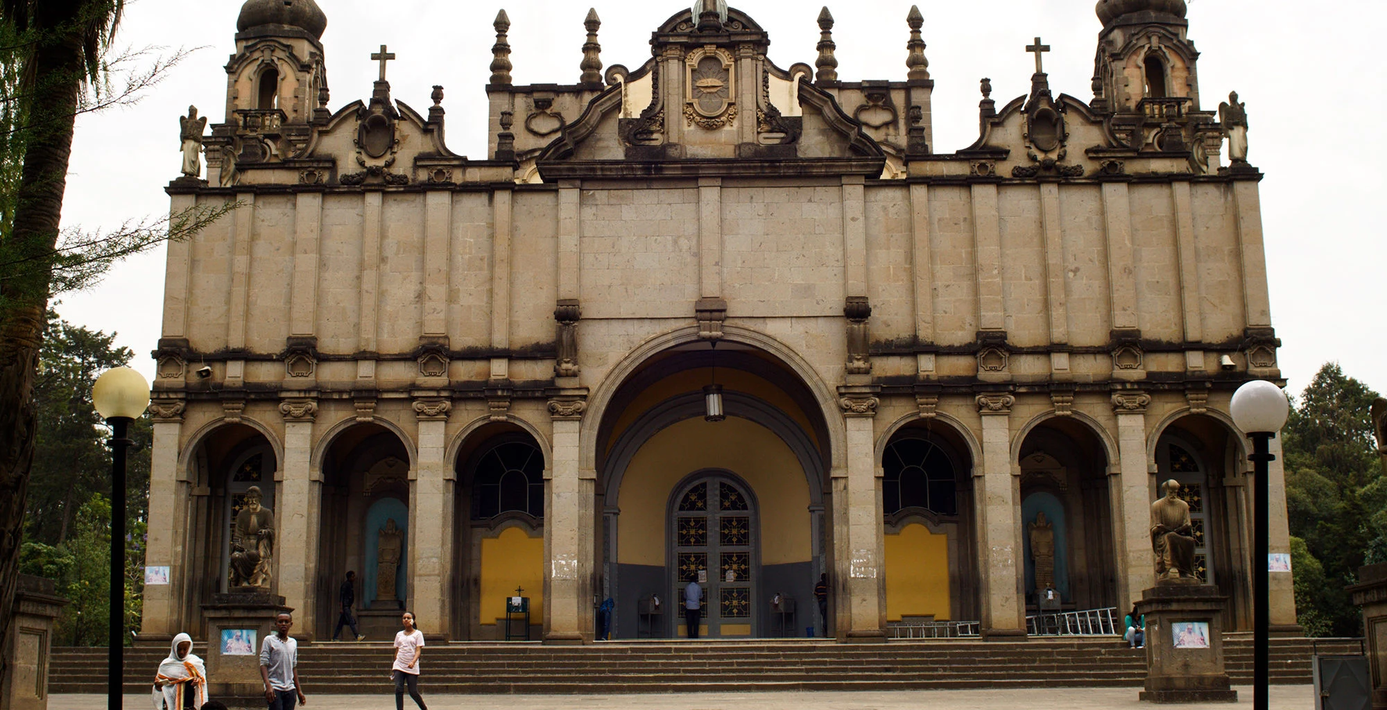 The stone facade and arcade of Holy Trinity Cathedral in Addis Ababa.