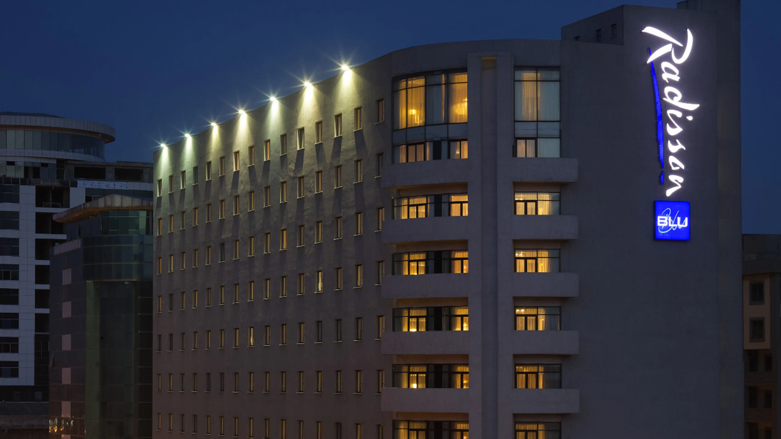 Illuminated hotel exterior at night at Radisson Blu Hotel, Addis Ababa