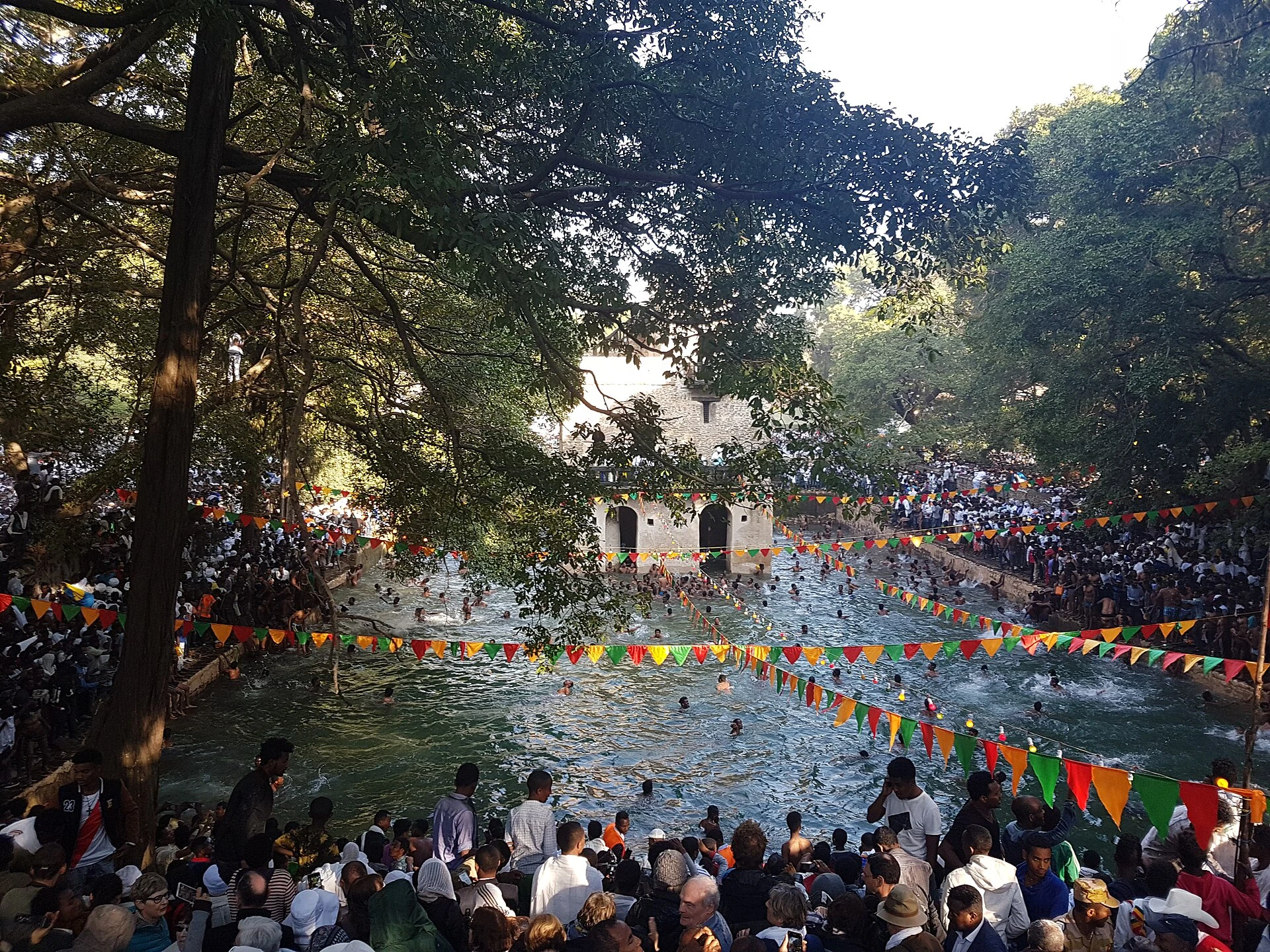 Crowds gather around the water of Fasilides' Bath during Timkat celebrations.