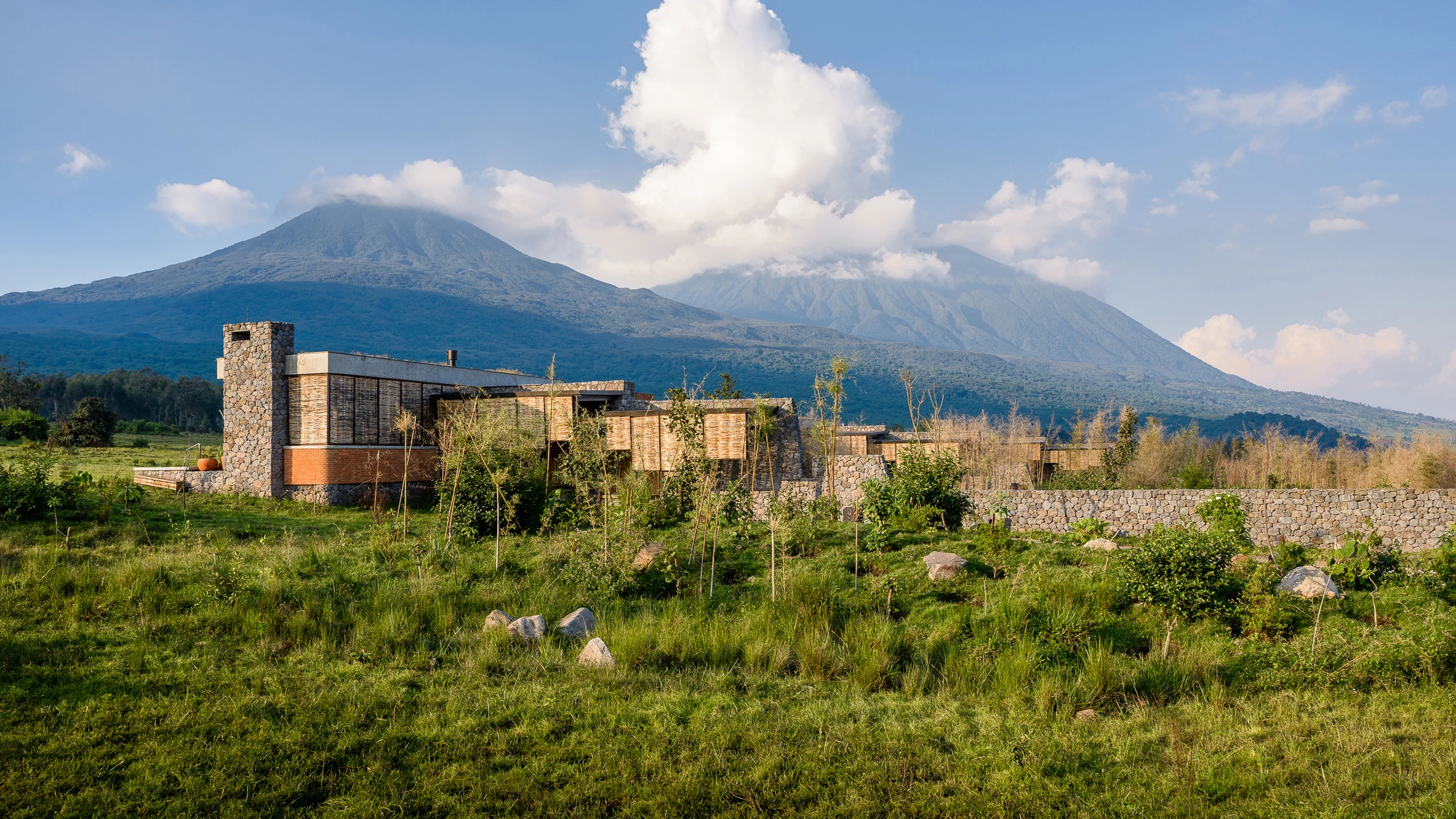 Modern stone lodge below mountain