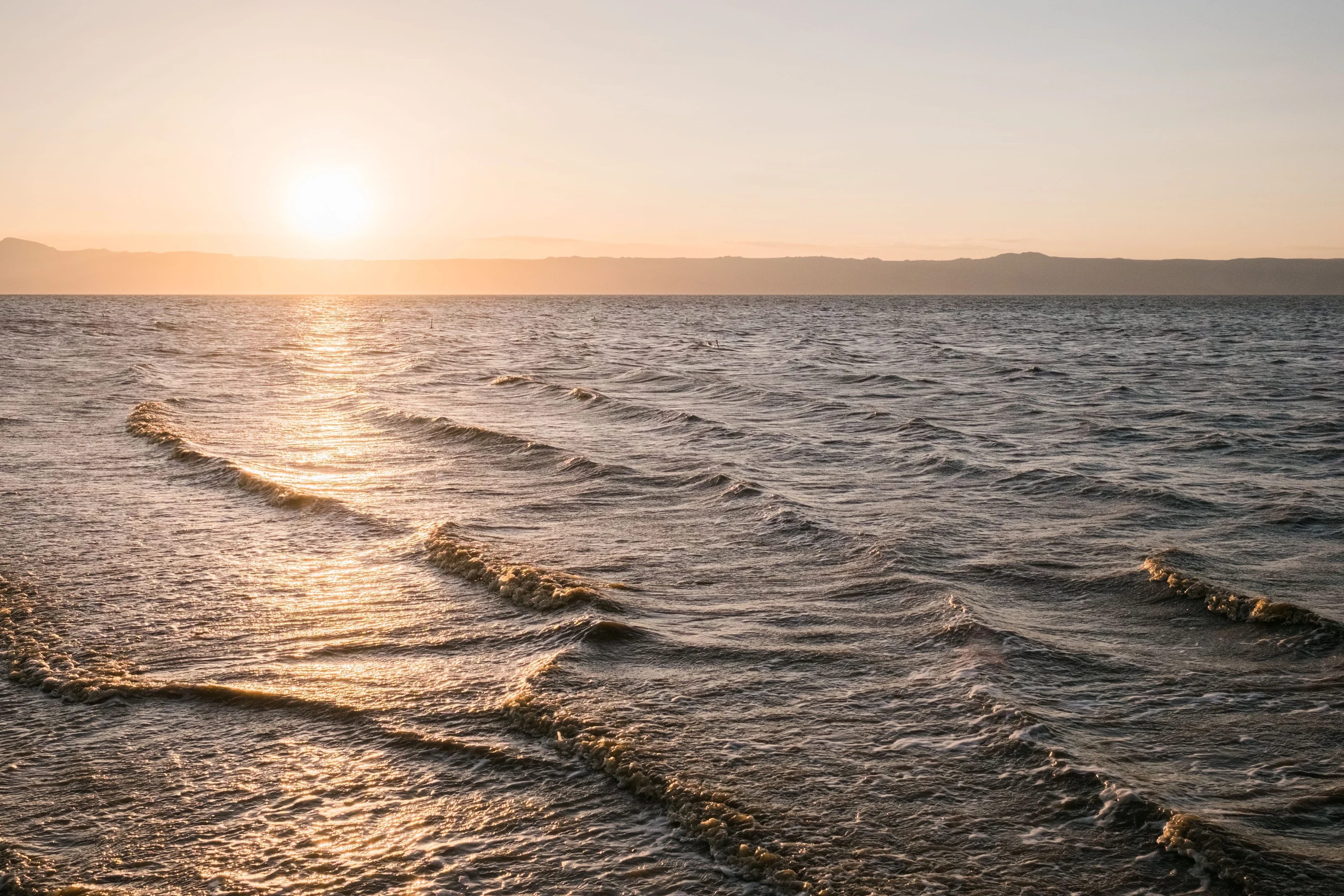 Sunset glow over rippling lake water