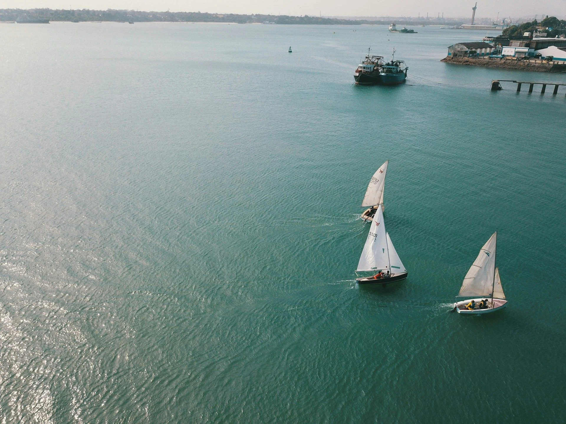 Aerial view of dhows sailing on green-blue water off Mombasa