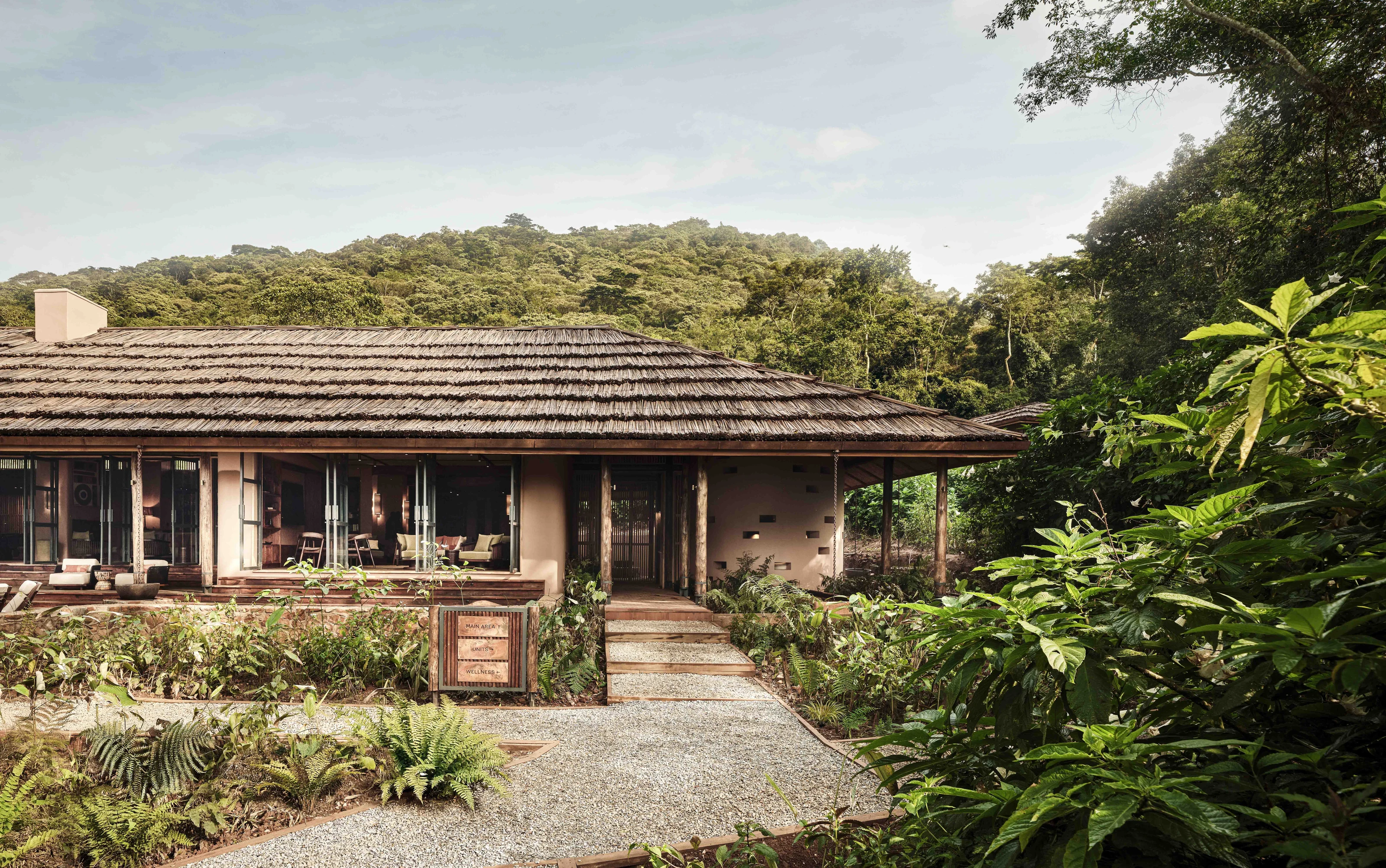 Lodge exterior and garden path at Gorilla Forest Lodge, an A&K Sanctuary