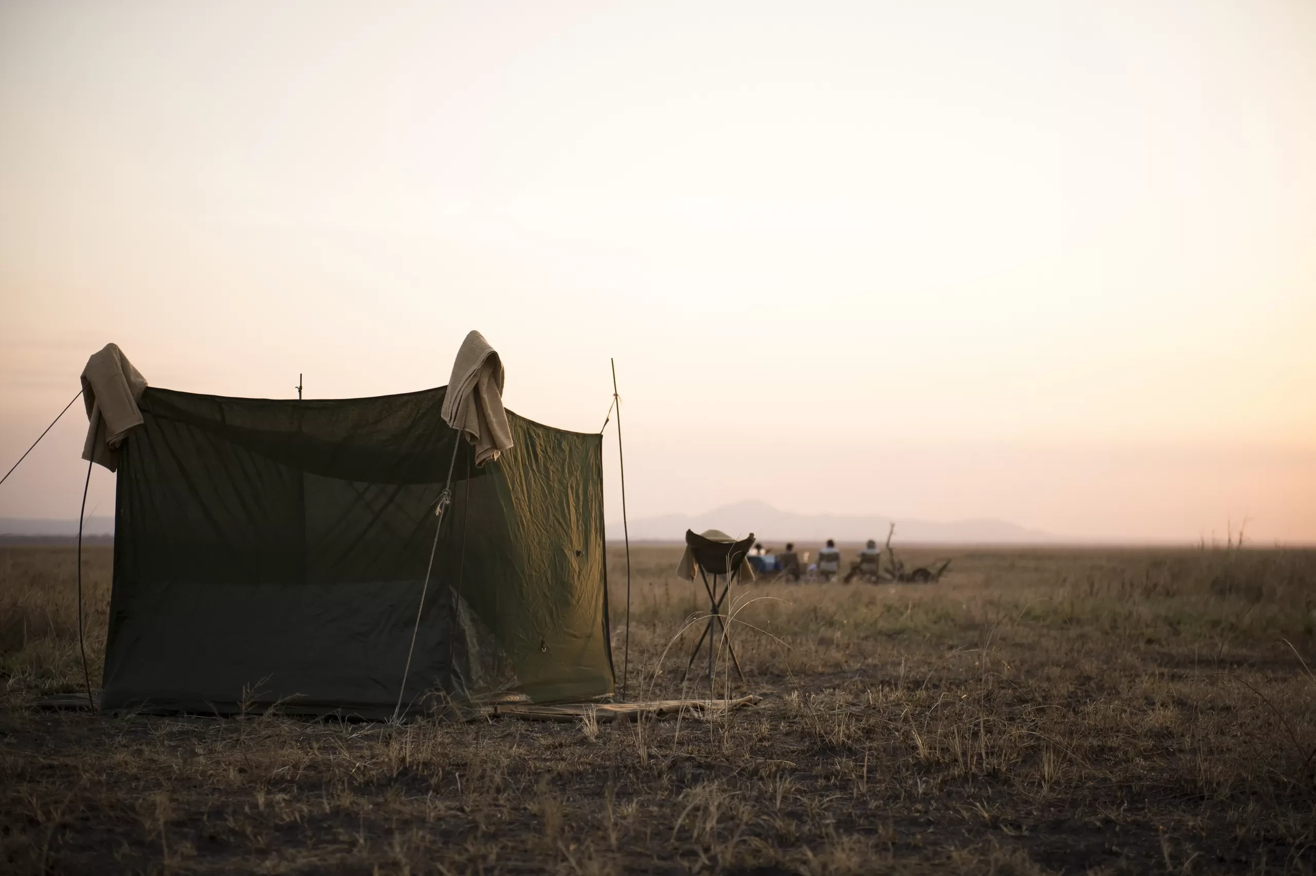 A small fly camp tent pitched on open plains in Katavi