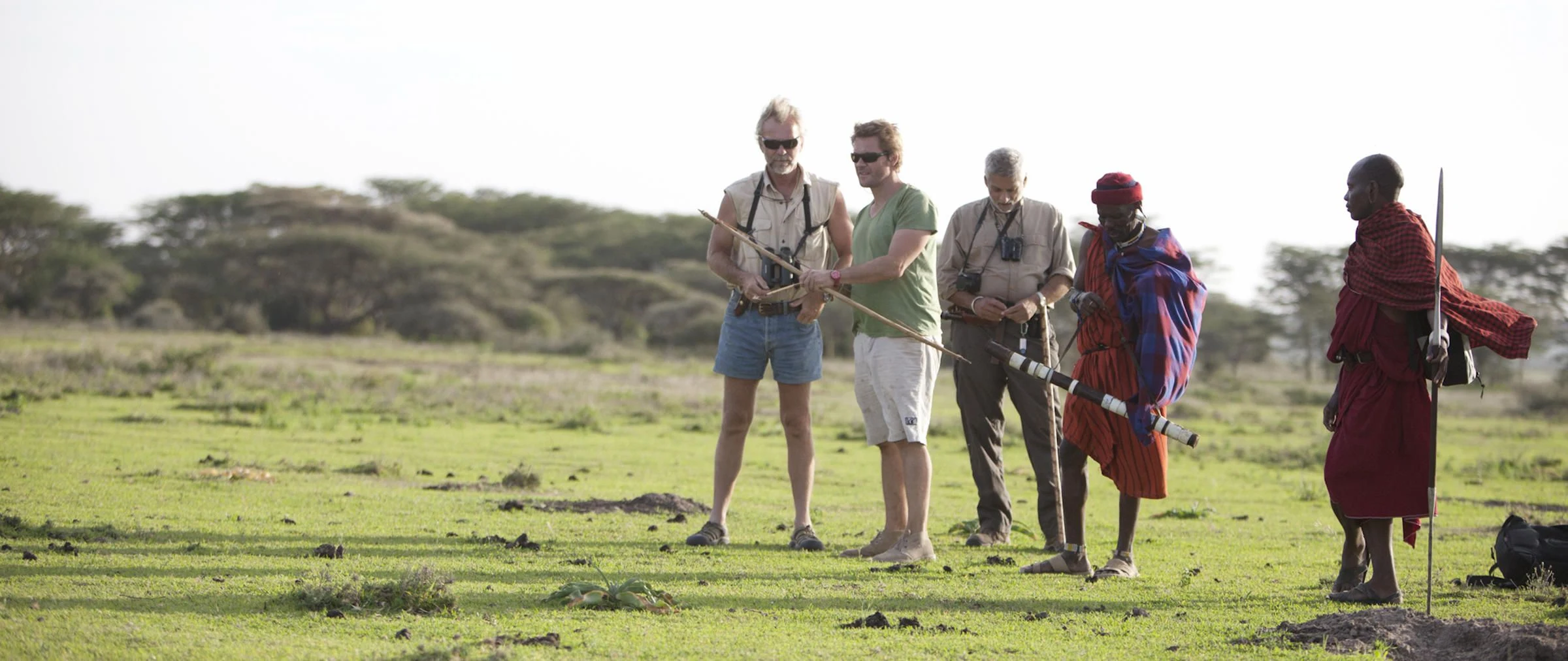 Walkers with a guide pausing on open plains in the Serengeti