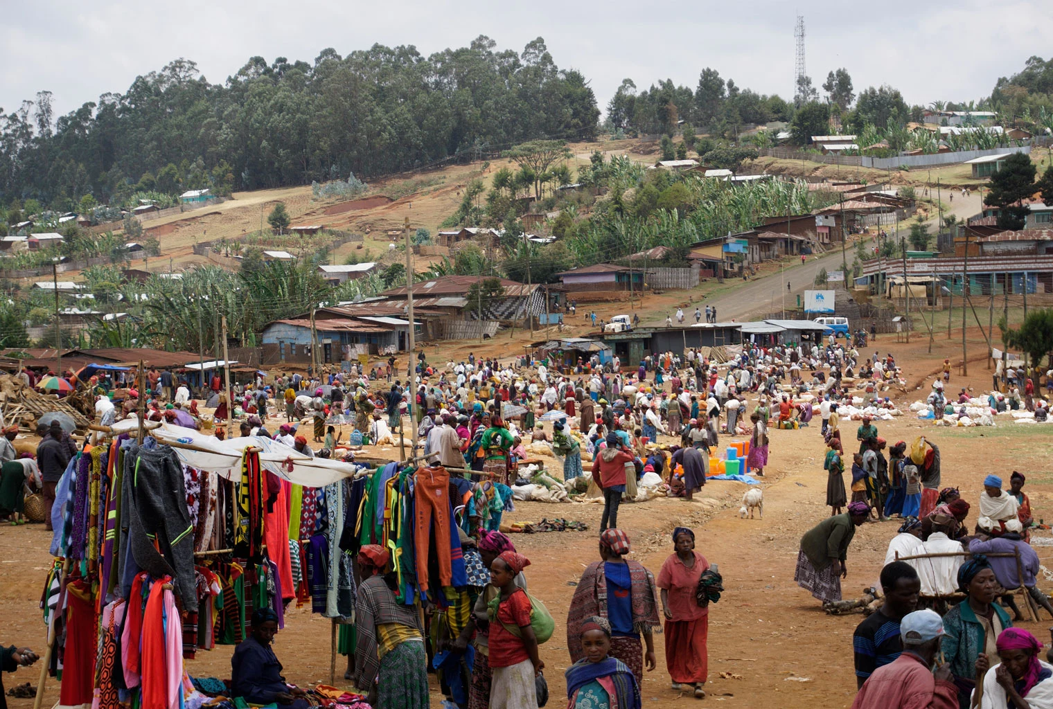A busy hillside market with clothing stalls in the Dorze highlands.