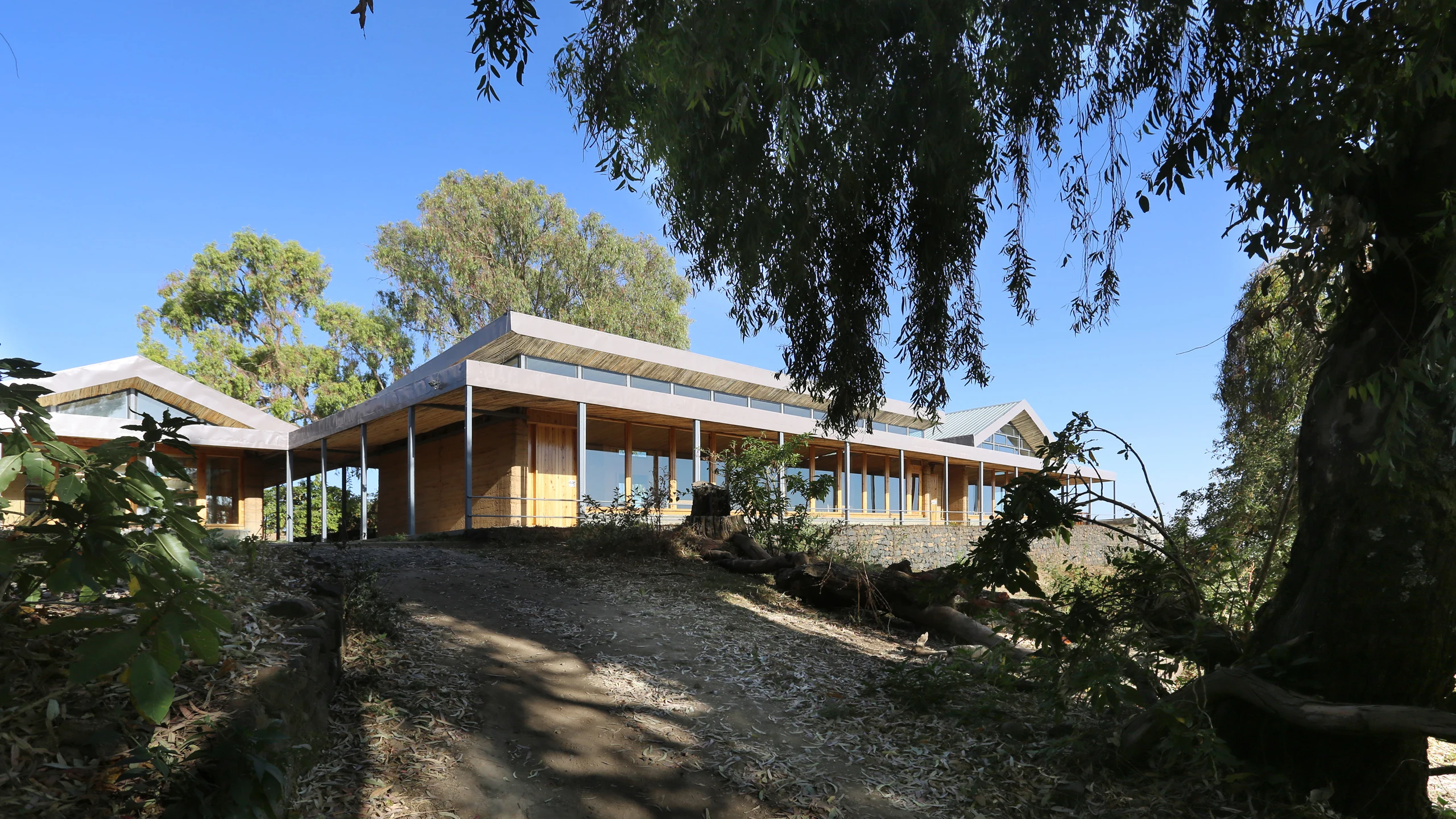 Low modern lodge buildings on the escarpment edge at Limalimo Lodge