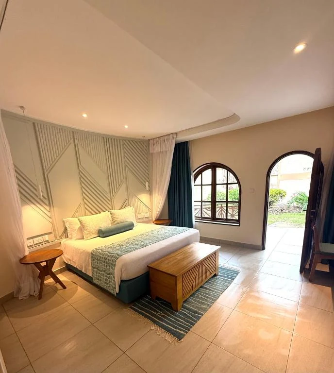 a large bedroom with a bed and a table