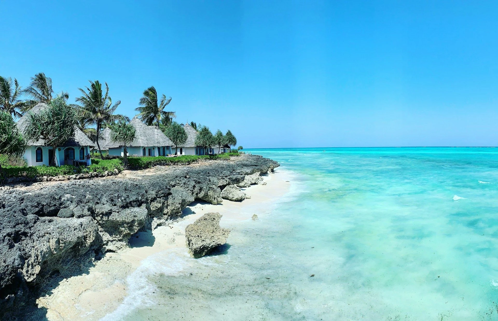 Beachfront cottages above a shallow turquoise shoreline
