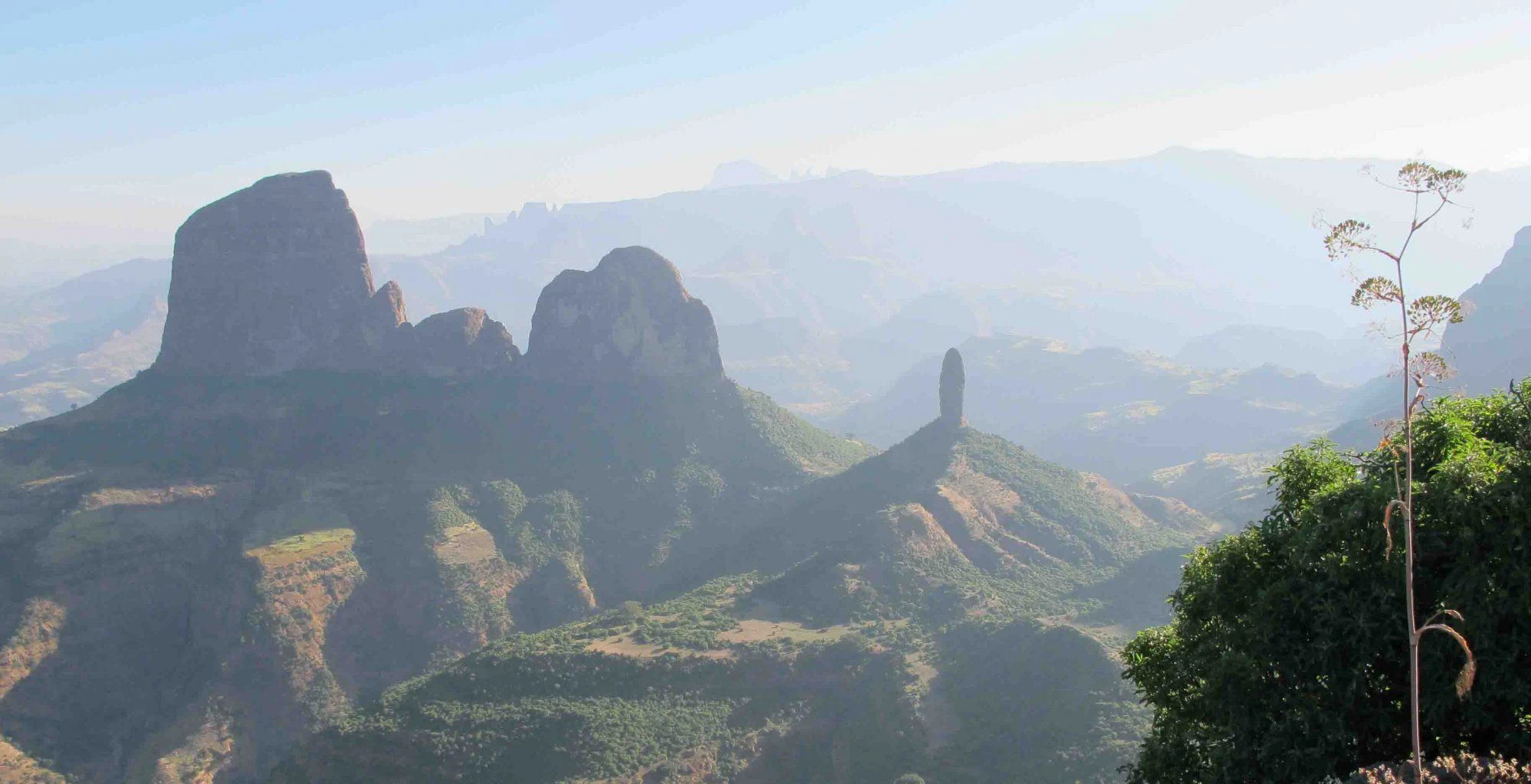 Jagged peaks and deep valleys of the Simien Mountains in morning haze.