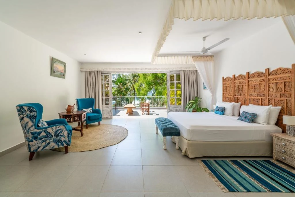a bedroom with a large bed and chairs in it