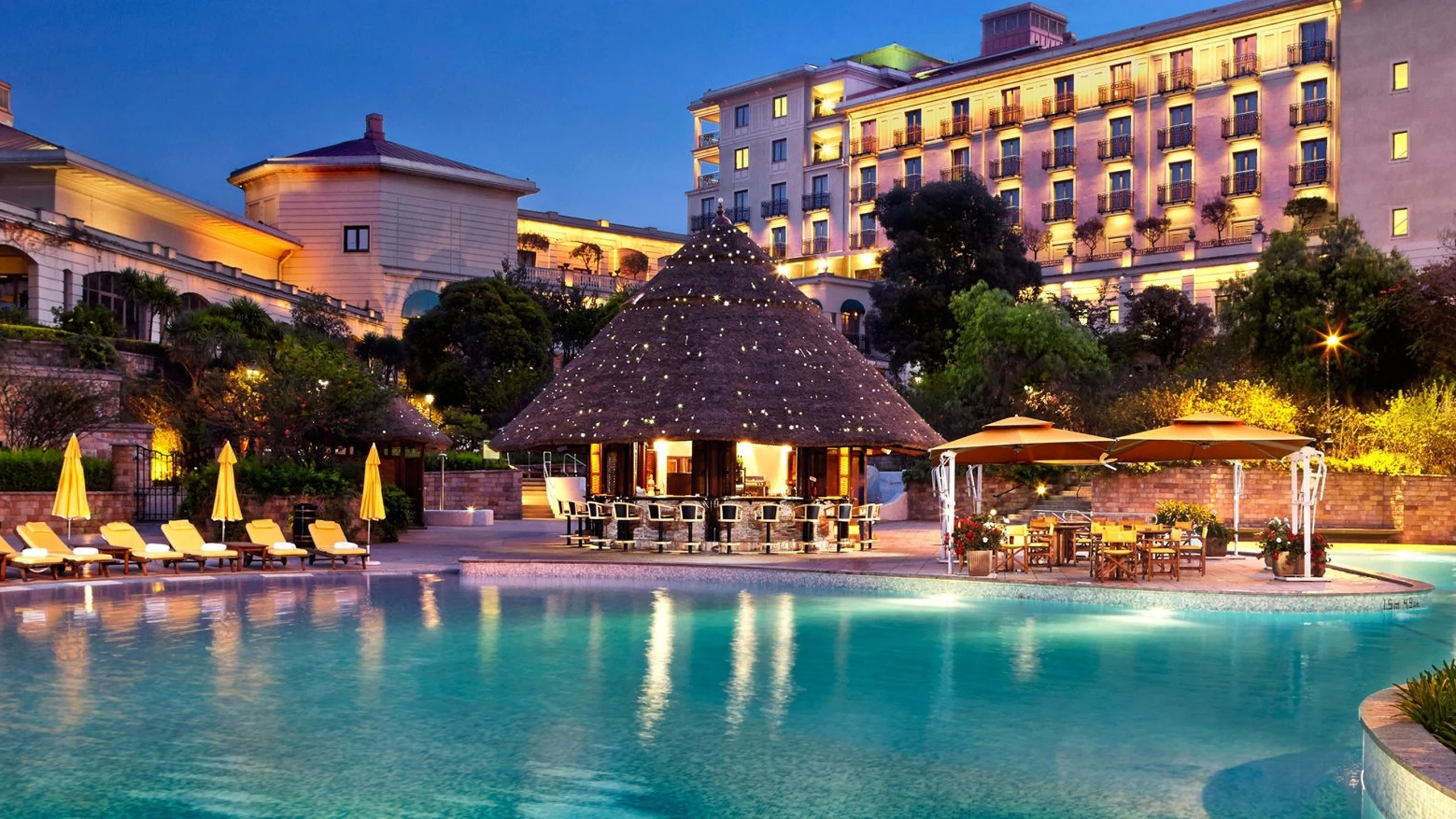 Illuminated hotel and swimming pool at dusk at Sheraton Addis, a Luxury Collection Hotel, Addis Ababa