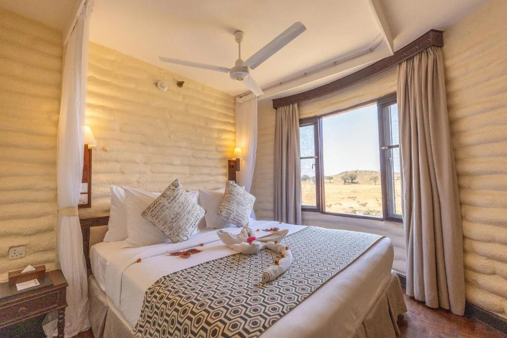 a bedroom with a bed with two stuffed animals on it