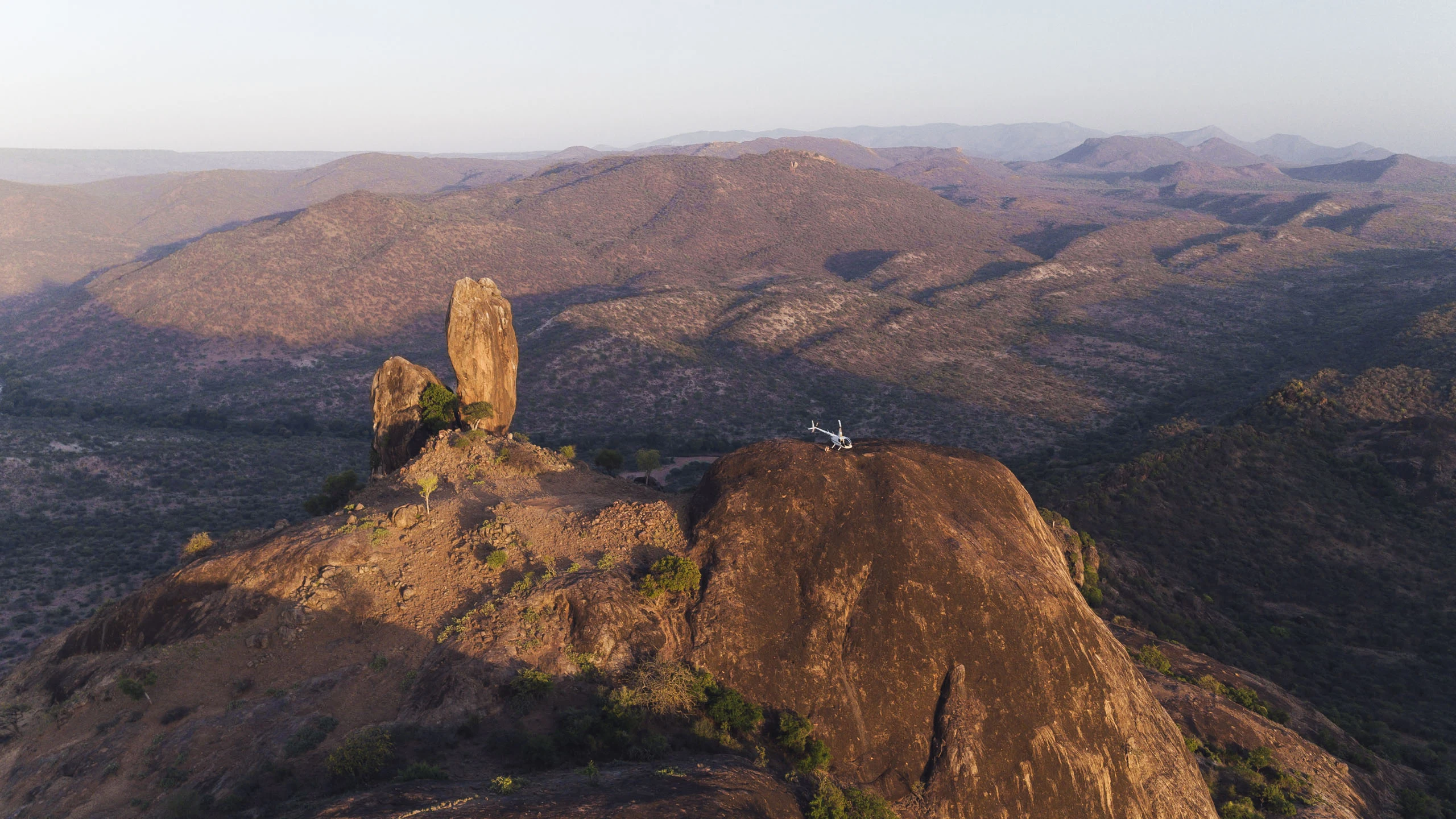 Rocky ridges and a rock pillar glowing in evening light