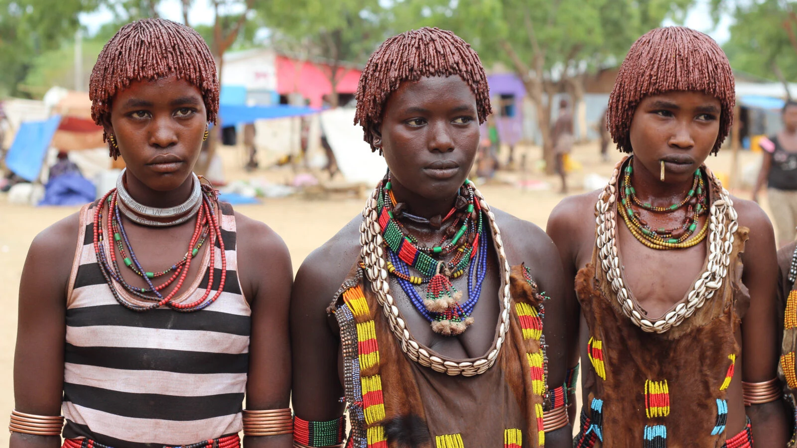 Three Hamar girls with ochre hair and bead necklaces in the Omo Valley