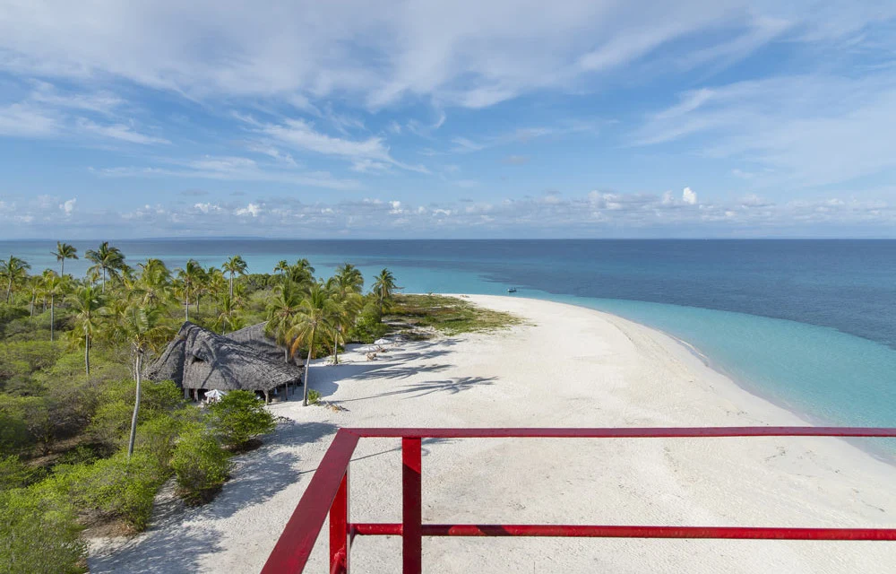 A white sandspit and turquoise water seen from a lookout