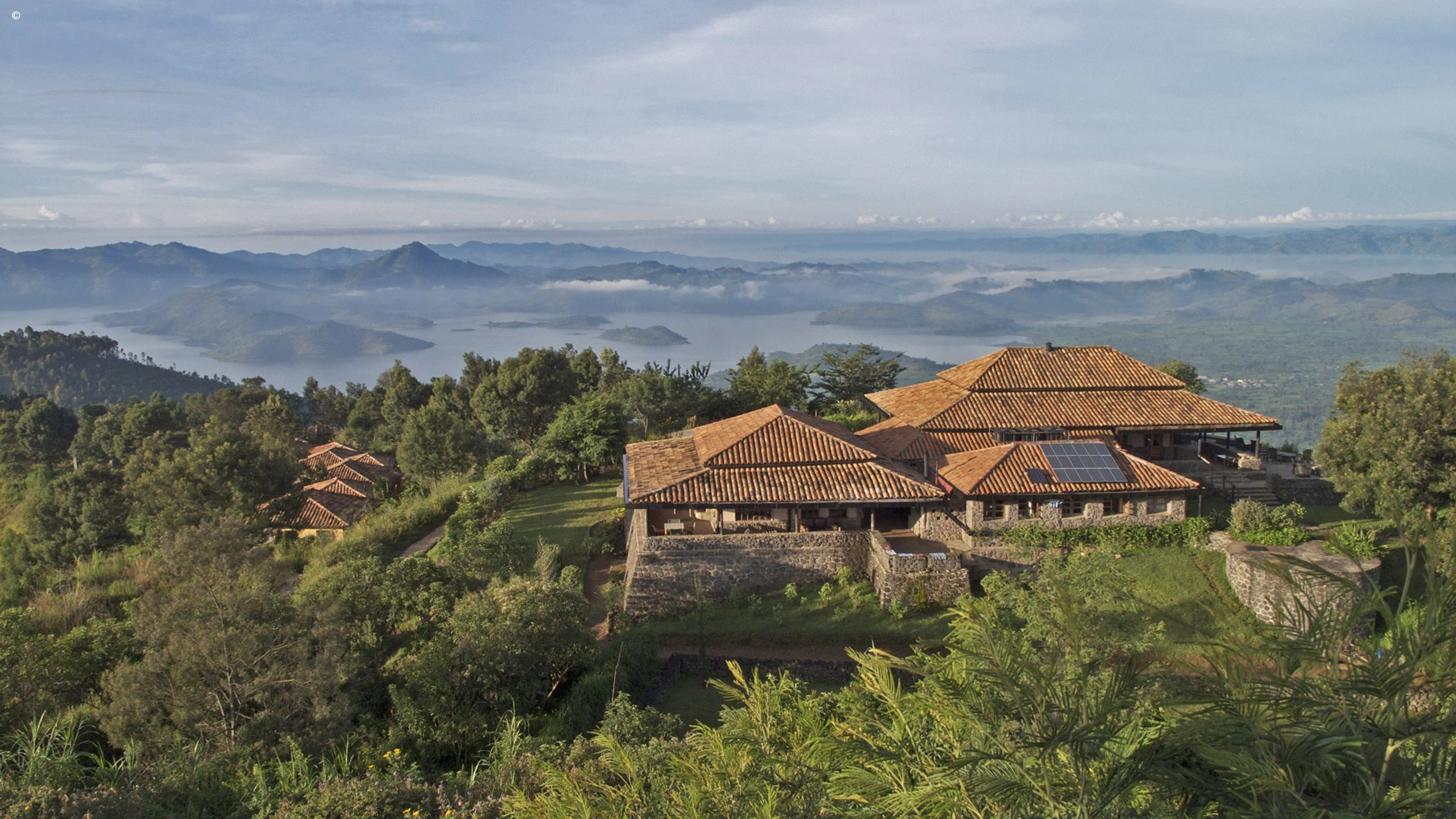 Hilltop lodge with tiled roofs at Virunga Lodge
