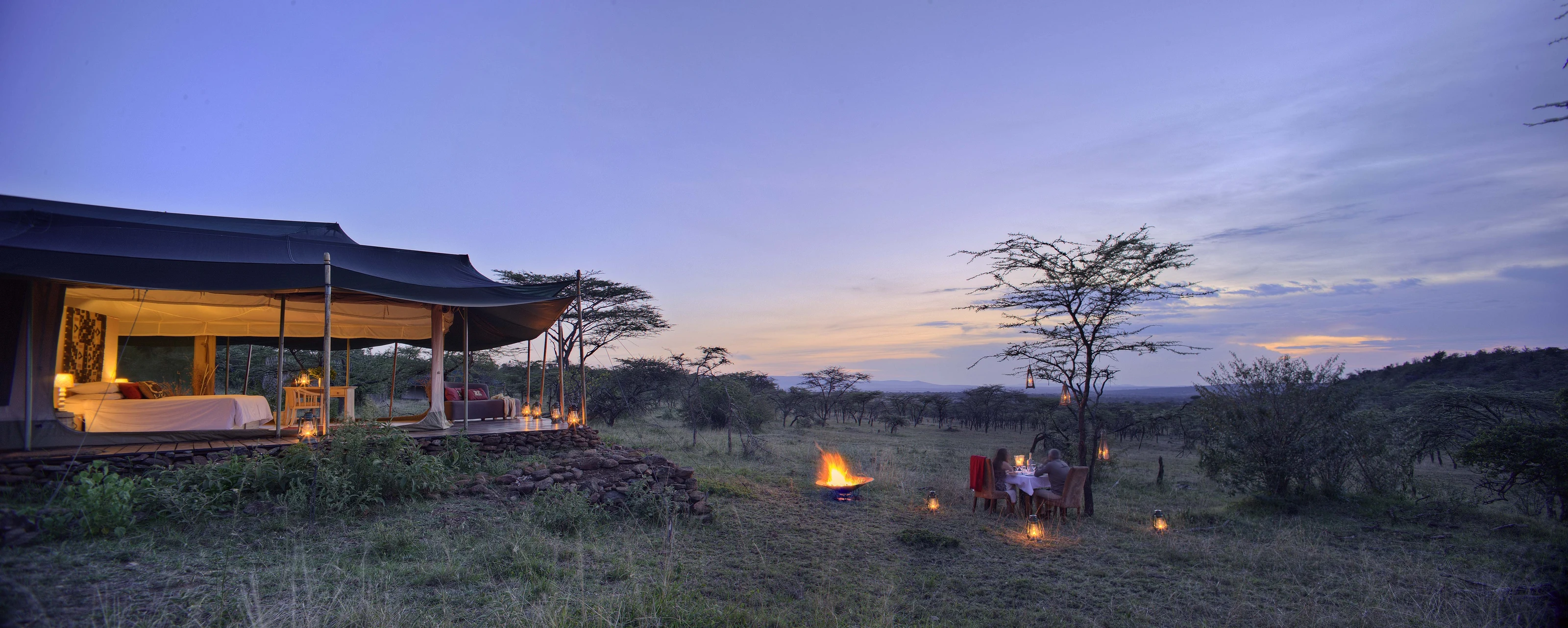 Lodge and firepit at dusk at Kicheche Valley Camp