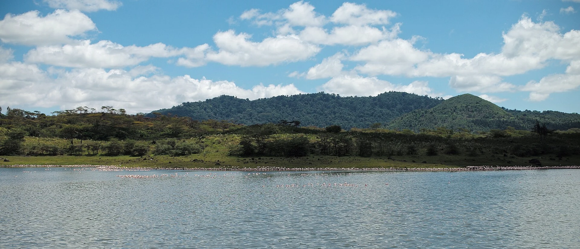 Momella Lake in Arusha National Park with forested hills behind