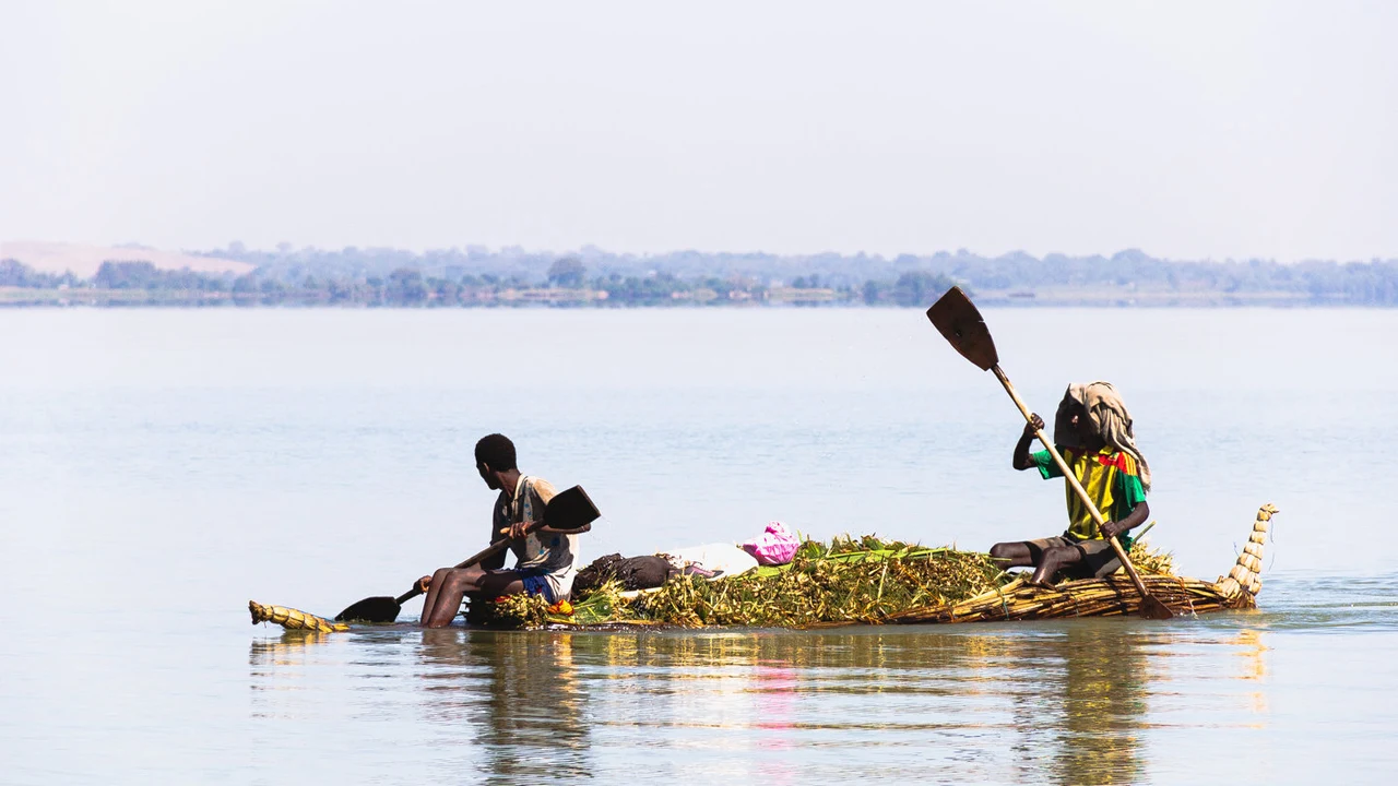 Two people paddling a papyrus boat on Lake Tana