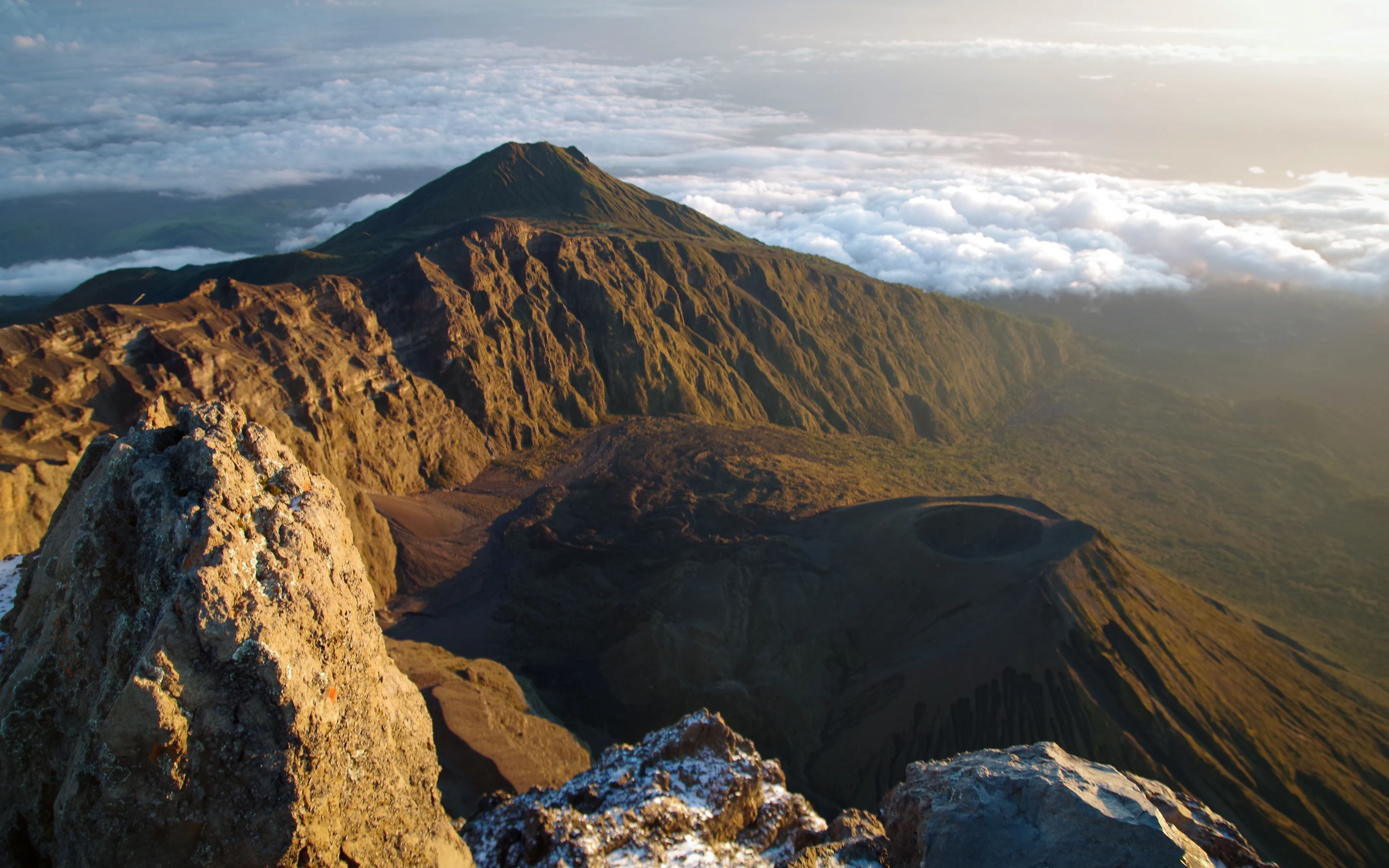 View from the summit of Mount Meru over the crater rim and clouds