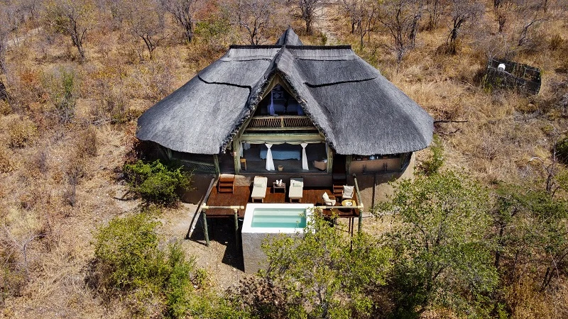 Thatched lodge with plunge pool at Ikuka Safari Camp