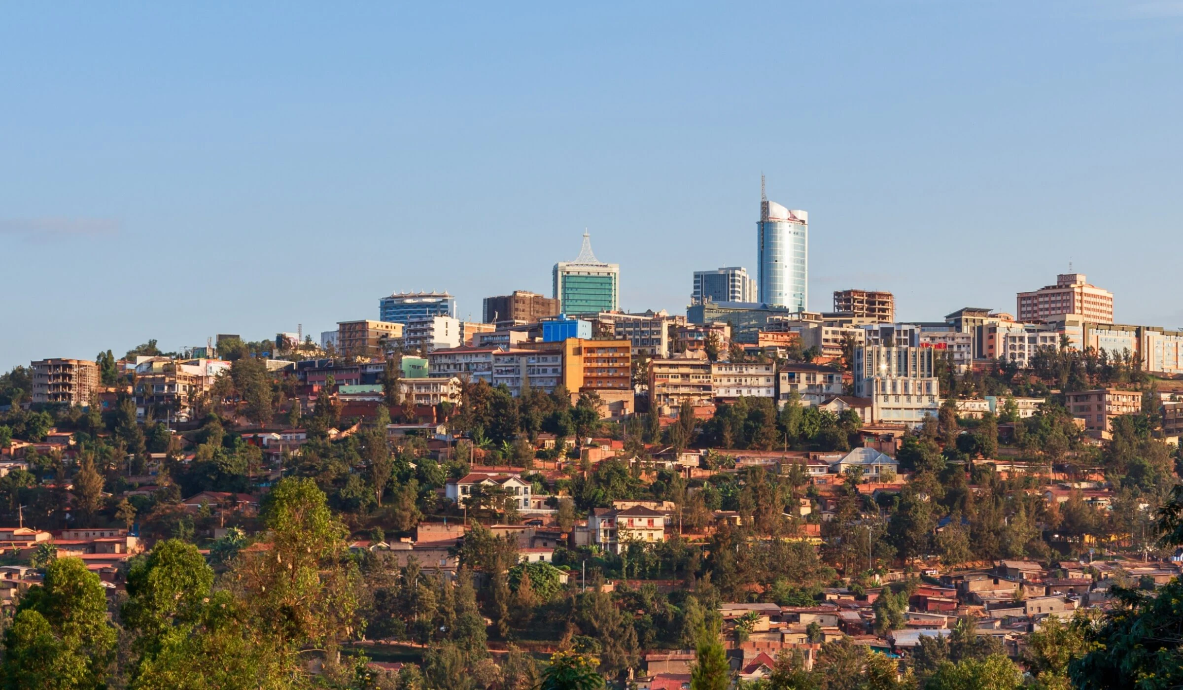 Kigali city centre towers above hillside neighbourhoods in clear light