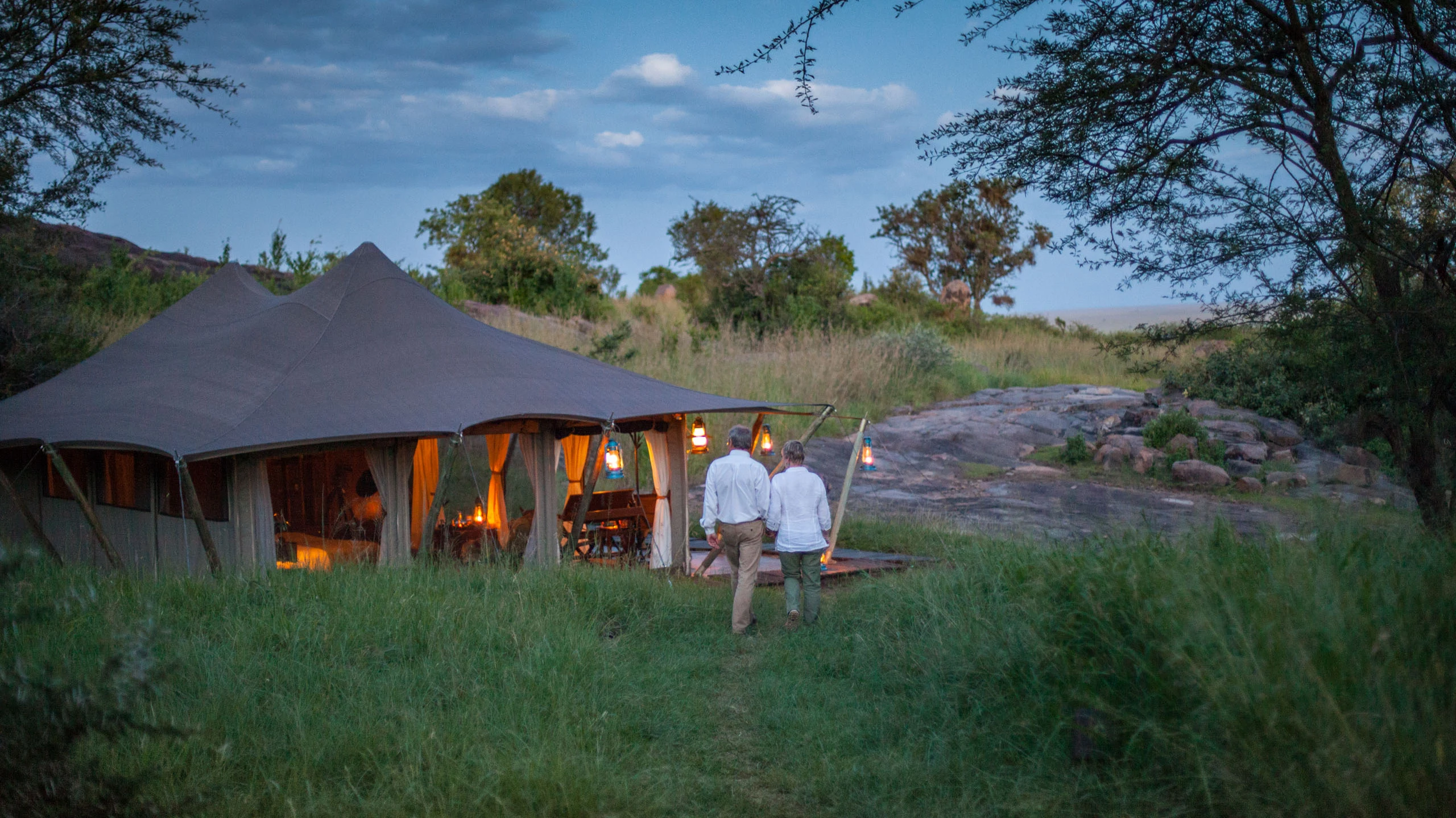 Canvas lodge beside tall grass at Serengeti Pioneer Camp