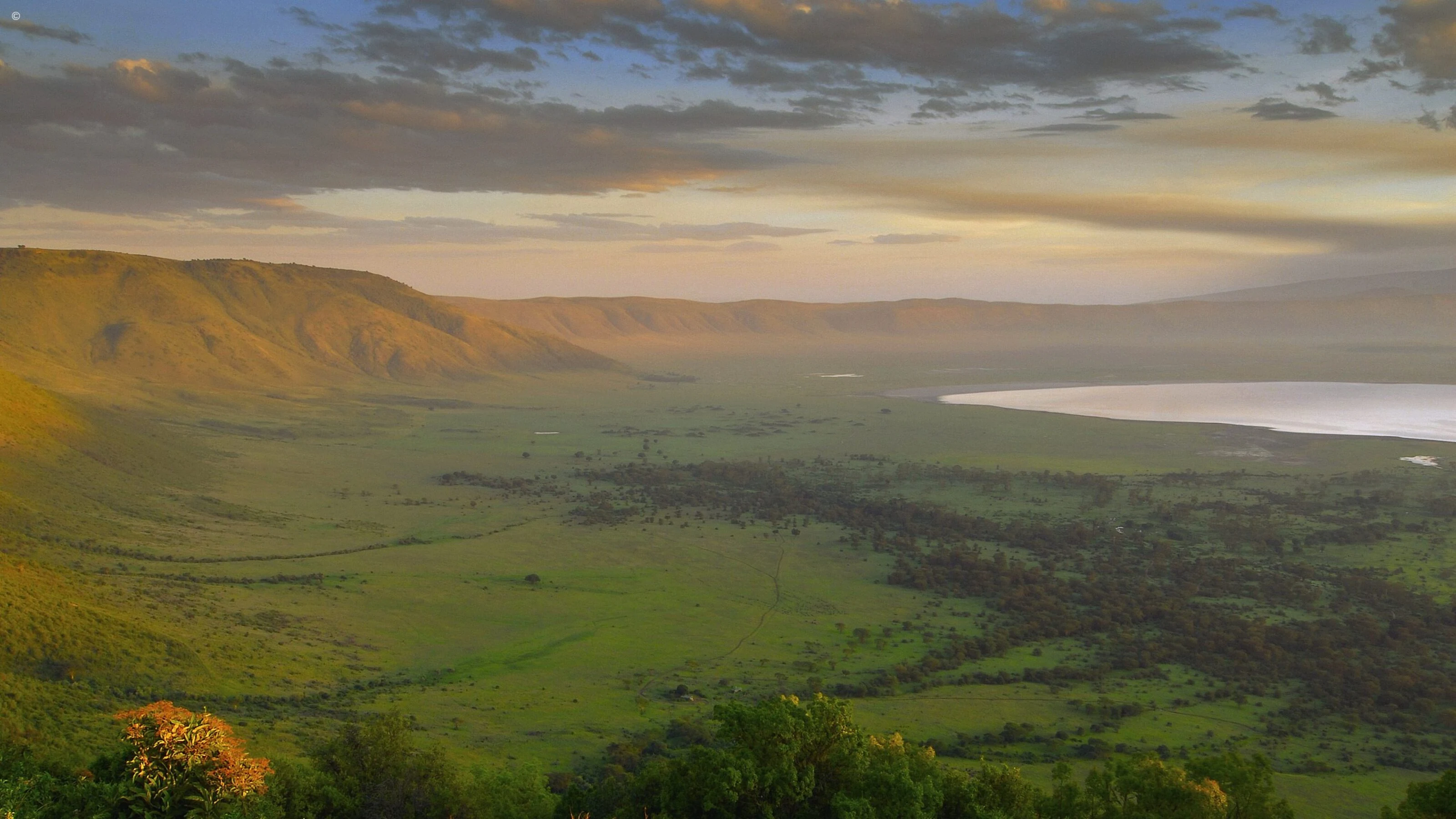 Wide crater with lake at golden sunset