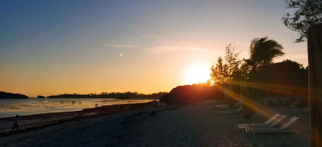 The sun setting over a calm bay on Kenya's coast