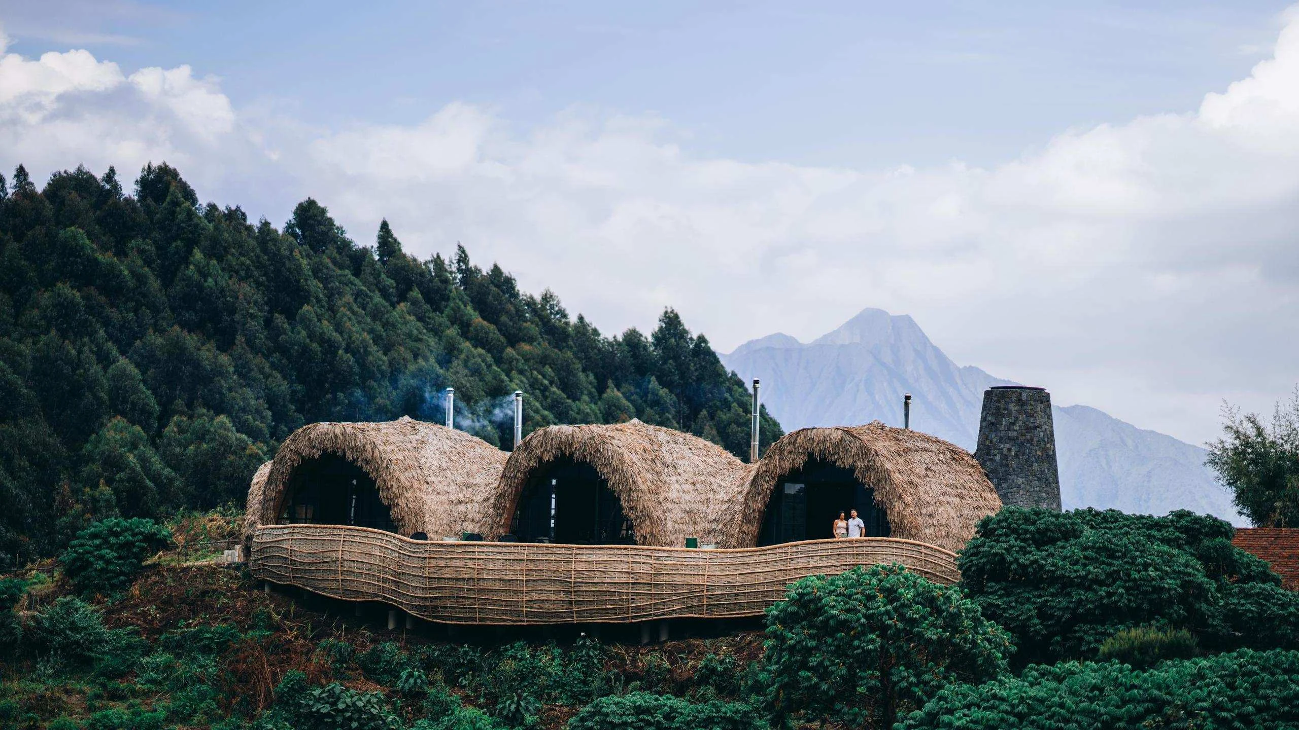 Rounded thatched lodges in green hills