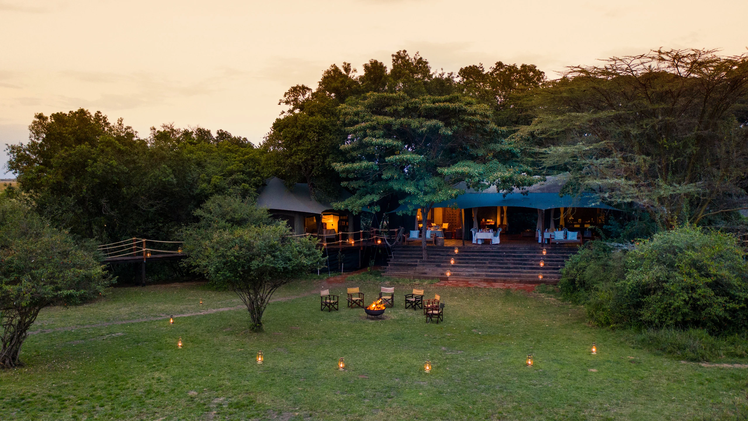 Lodge across a lantern dotted lawn at Mara Plains Camp