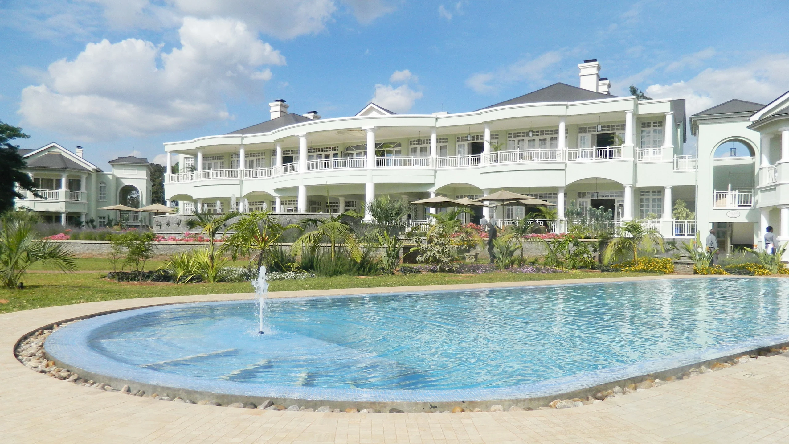 Oval pool beside white hotel at Hemingways Nairobi