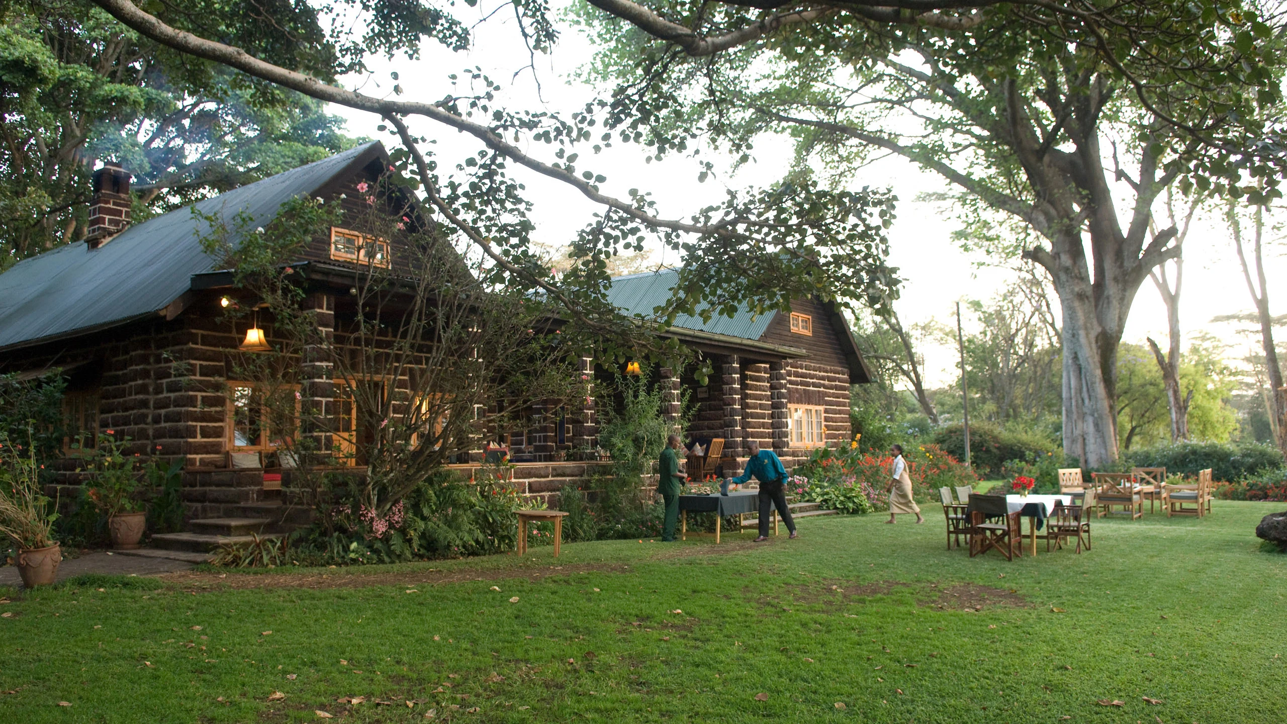Rustic cottages beside lawn at Loldia House