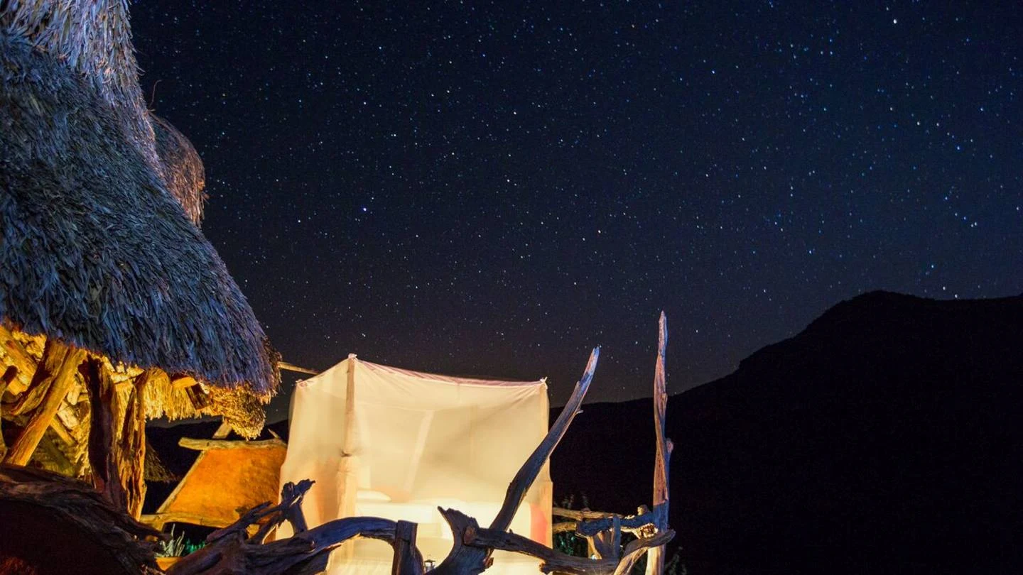 Stars over a tented camp at night