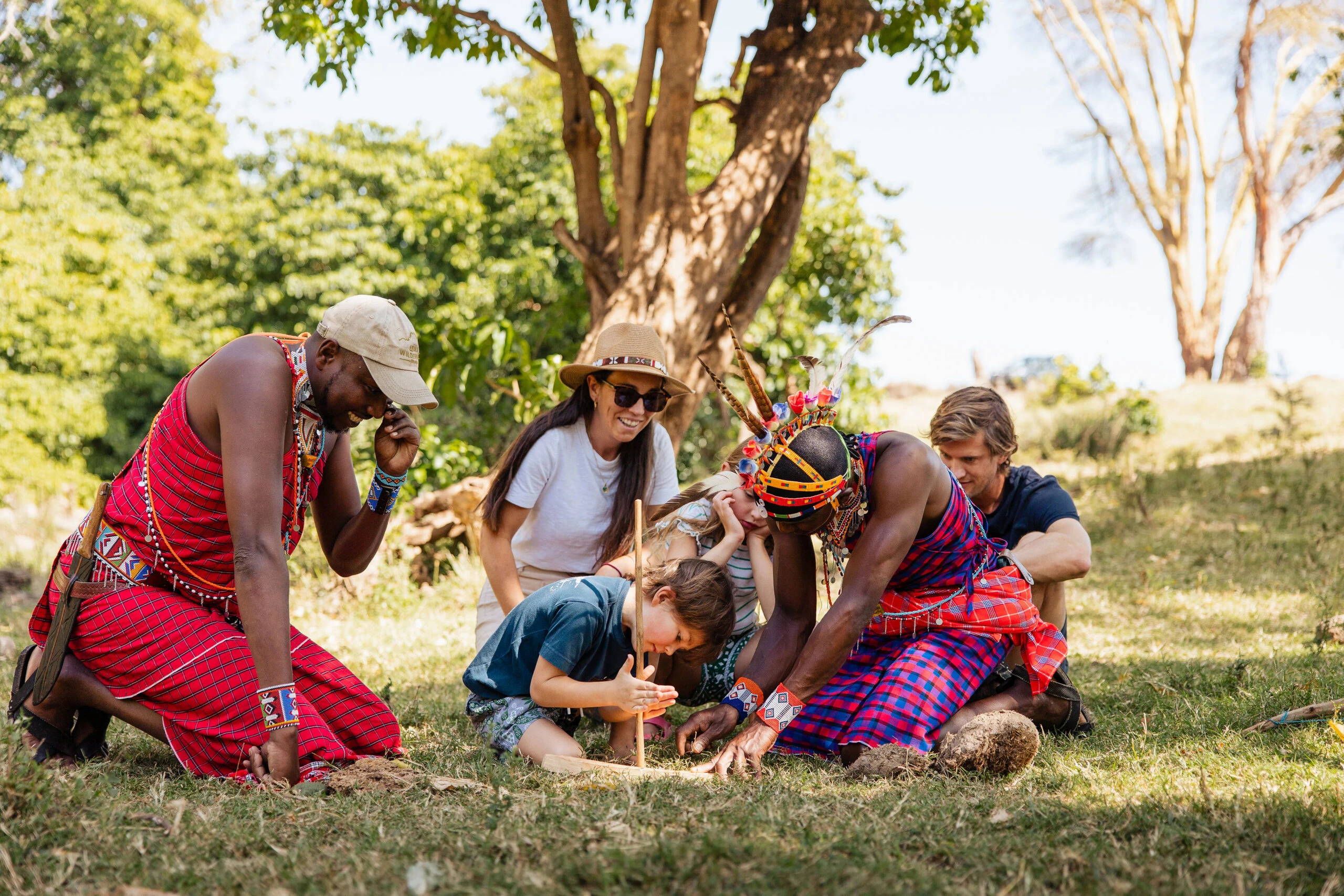 Guests learning to make fire with Maasai hosts at Lewa